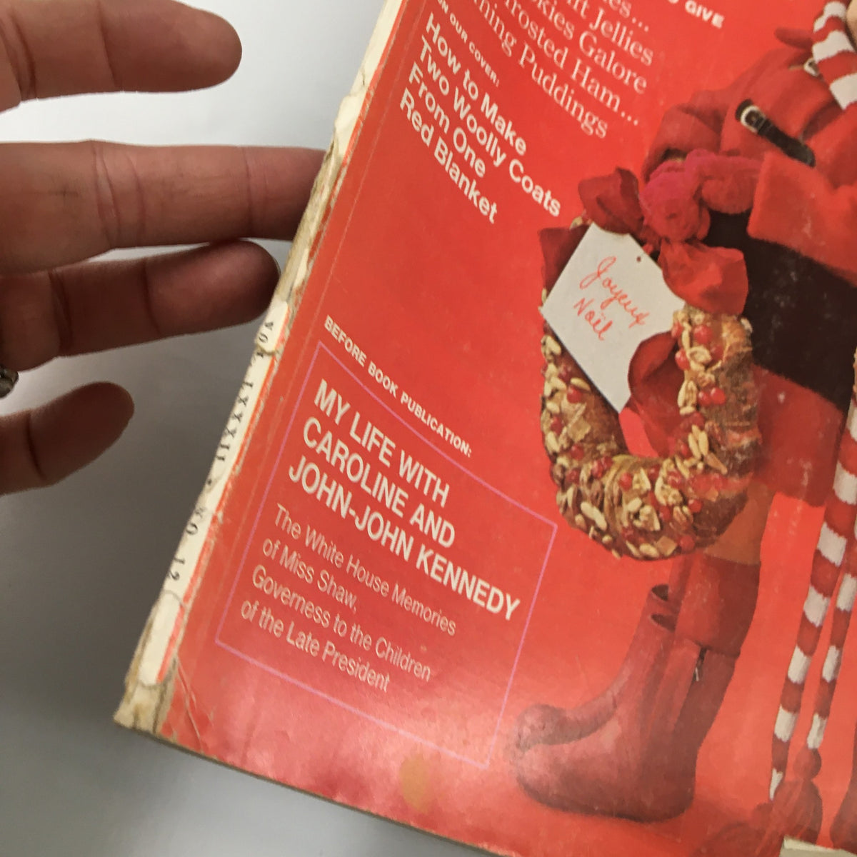 Close-up of the cover of Ladies' Home Journal Magazine December 1965 showing the article 'My Life with Caroline and John-John Kennedy' along with the title and festive decorations.