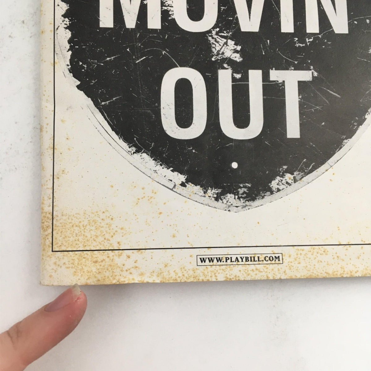 Cover image of the 2003 Playbill for Movin' Out by Twyla Tharp and Billy Joel, showing the title 'Movin' Out' with an aged appearance.