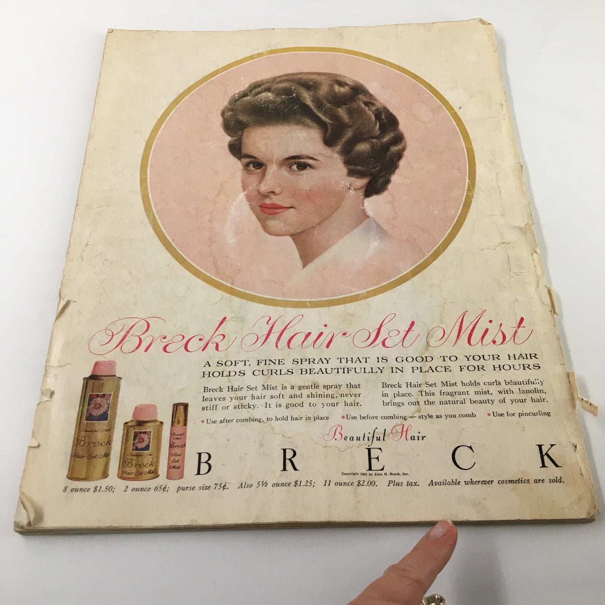 Back cover of Ladies' Home Journal Magazine from June 1961 featuring an advertisement for Breck Hair Set Mist with a vintage illustrated woman model, reflecting beauty and hair care trends of the era.