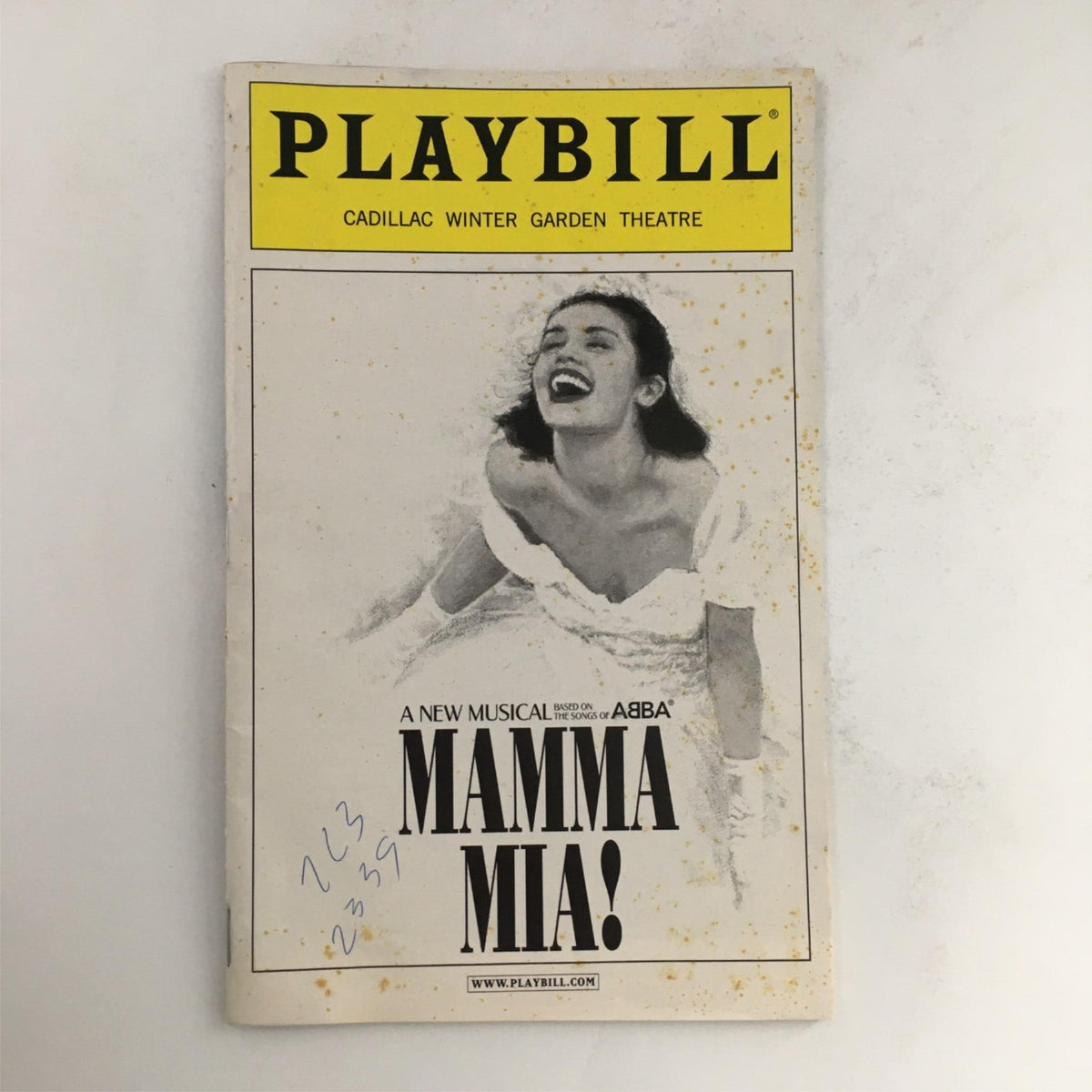 2002 Playbill for Mamma Mia! directed by Phyllida Lloyd at Cadillac Winter Garden Theatre featuring a joyful actress on the cover.