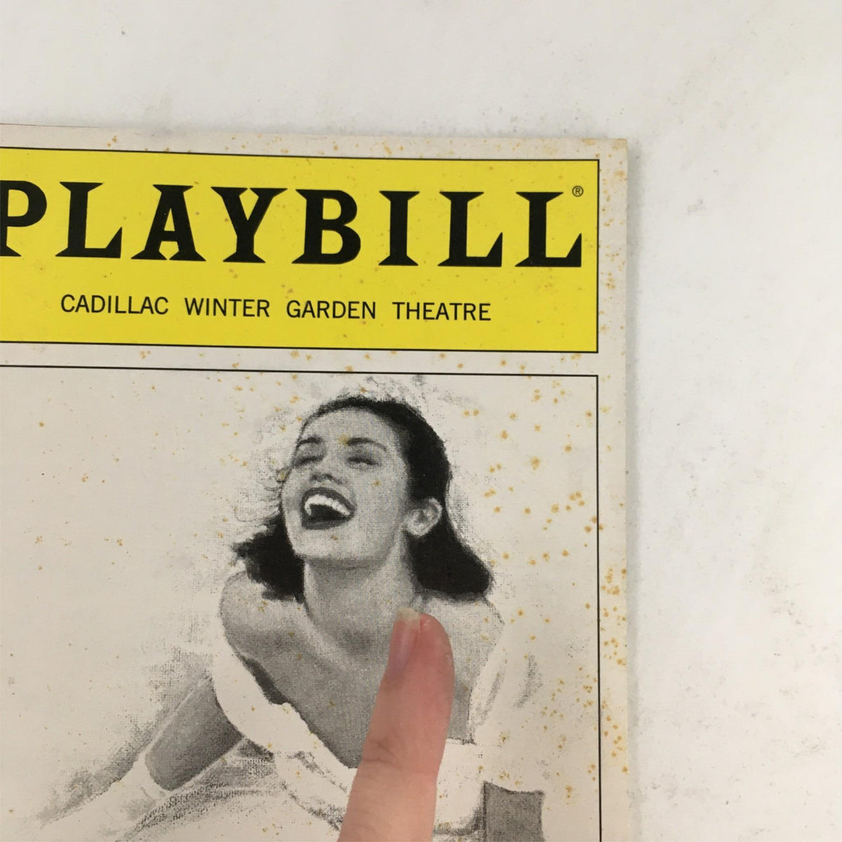 Front page of the 2002 Playbill Mamma Mia! at Cadillac Winter Garden Theatre, featuring a smiling actress and signs of aging.