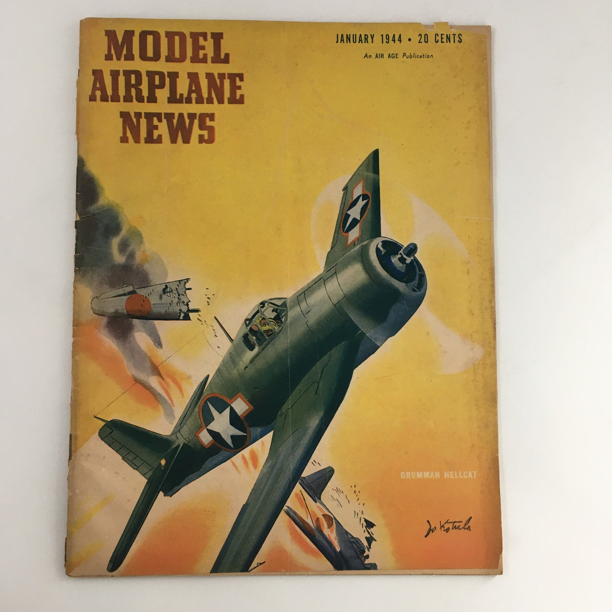Cover of Model Airplane News Magazine January 1944 featuring an illustration of a Grumman Hellcat aircraft and explosive scenes, highlighting aviation history.