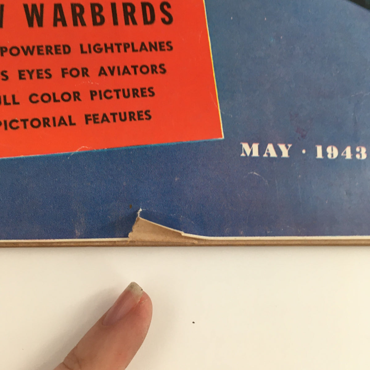 Close-up view of Air Progress Magazine May 1943 cover highlighting Pictorial Features and dates, with visible edge wear.