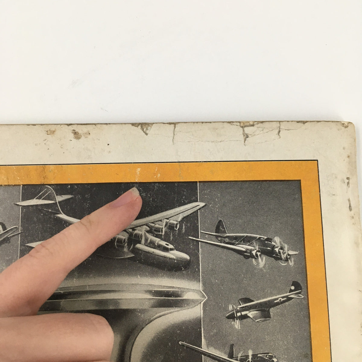 Close-up view of the cover of Popular Aviation Magazine January 1938, showcasing vintage aircraft illustrations and the title "Uncle Sam Warplane Salesman" with a finger pointing at the features.