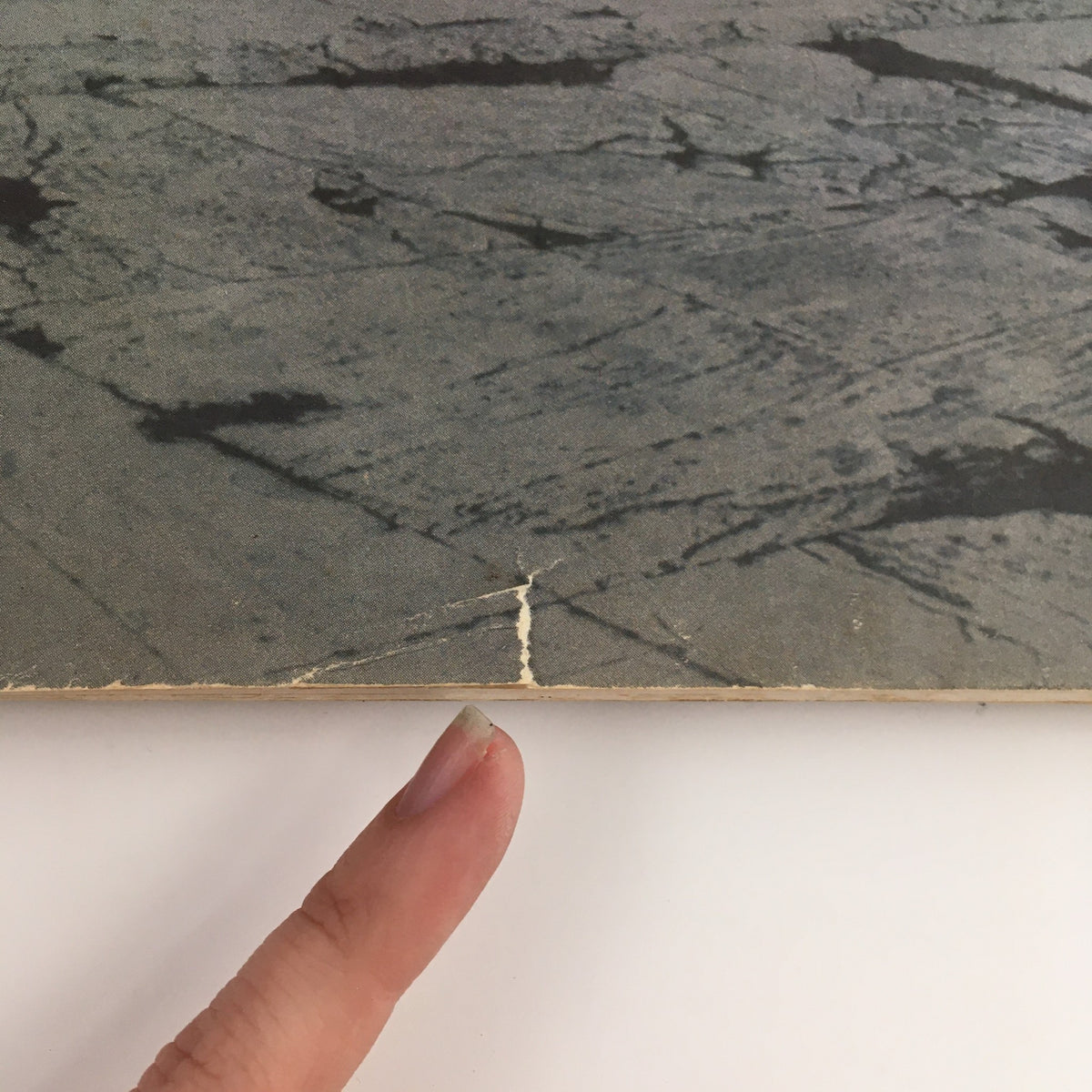 Close-up image of VTG Fortune Magazine May 1945, highlighting a damaged corner of the cover, showcasing signs of wear consistent with its vintage character.