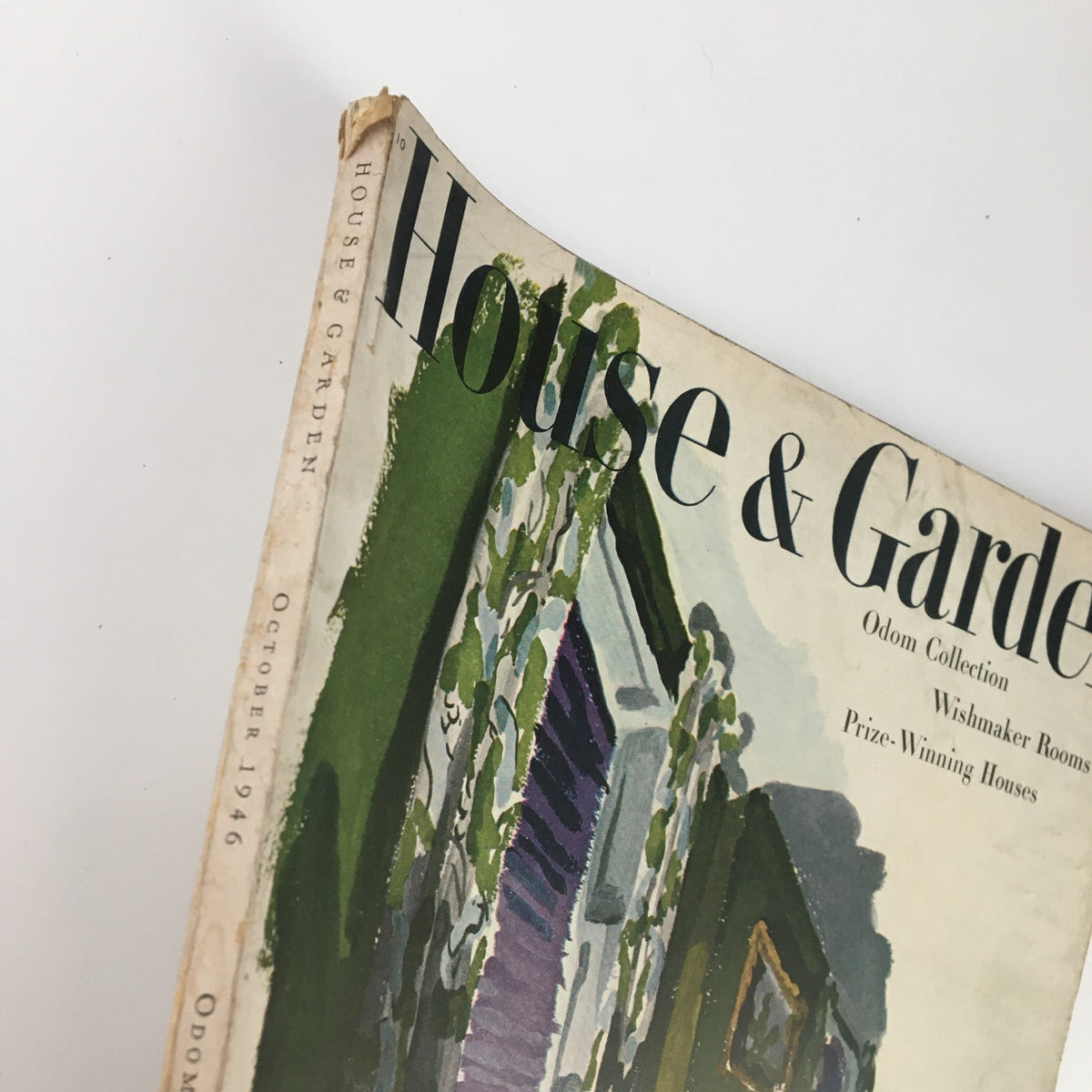 Angled view of the VTG House & Garden Magazine, October 1946, showing the vintage cover with decorative designs and text regarding Odom Collection, Wishmaker Rooms, and Prize-Winning Houses.