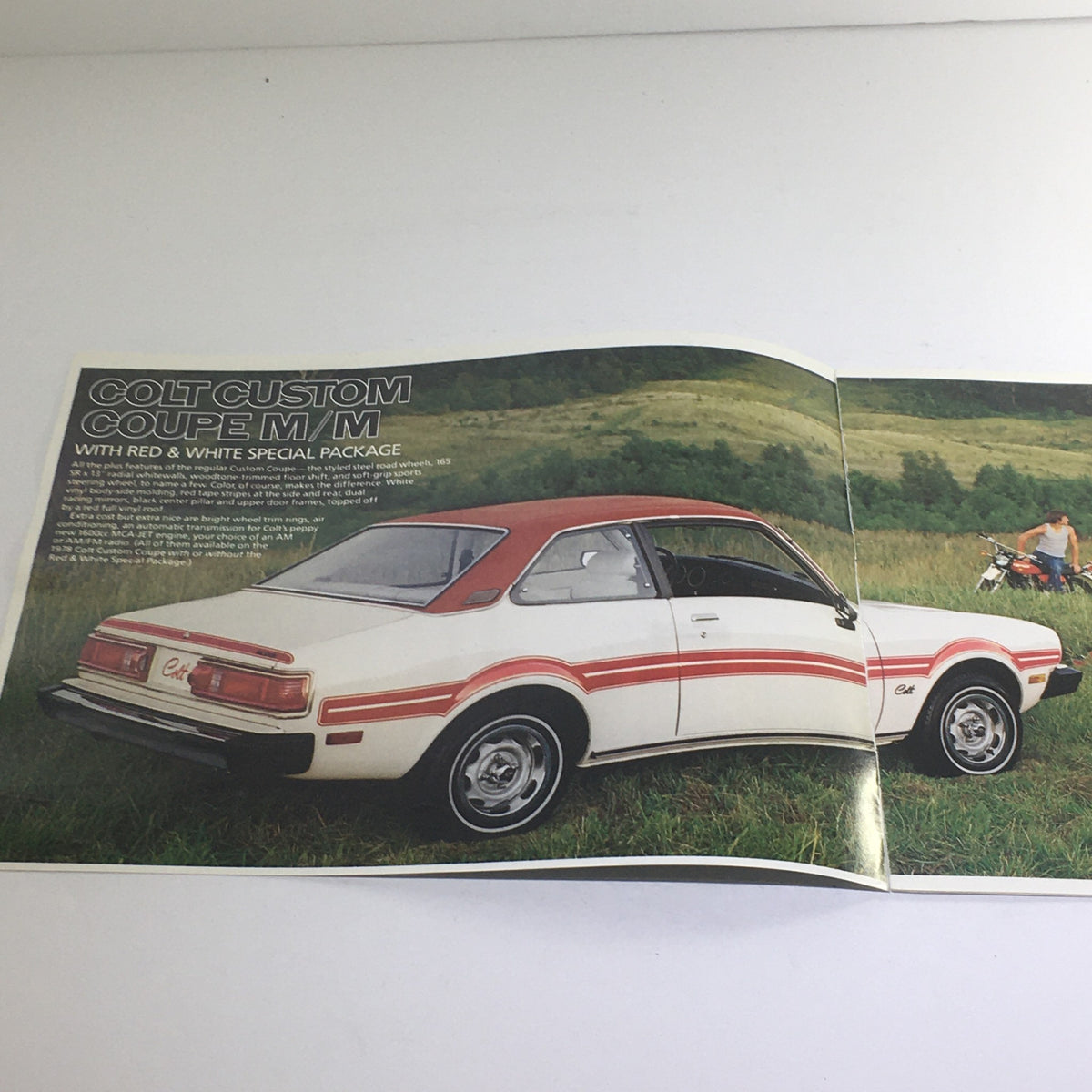 1978 Dodge Cold Custom Coupe M/M Dealership Car Auto Brochure showcasing the Colt Custom Coupe parked in a grassy field, featuring a red and white special package.