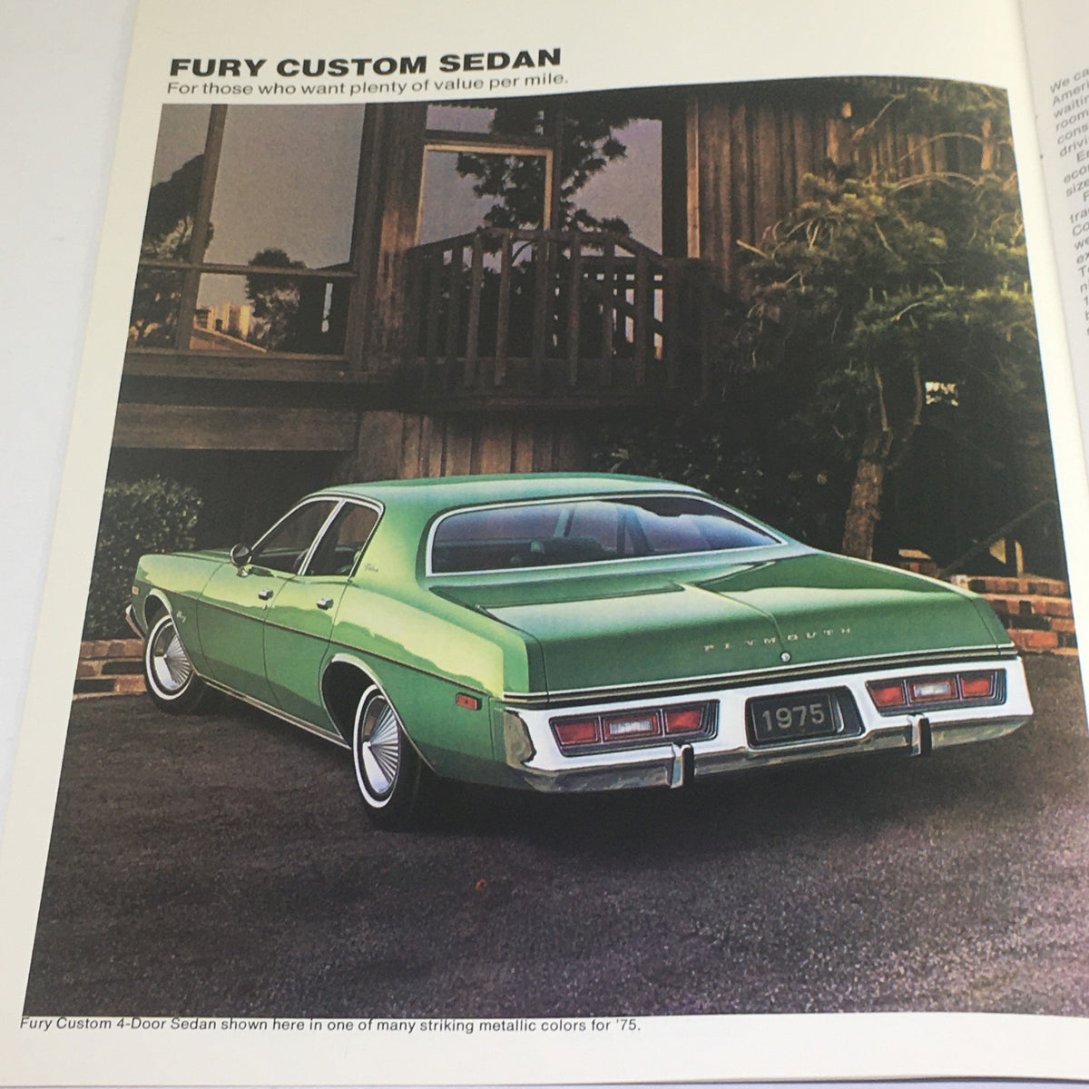 1975 Plymouth Small Fury Custom Sedan showing a rear view of a green sedan in a residential area, part of the dealership brochure.