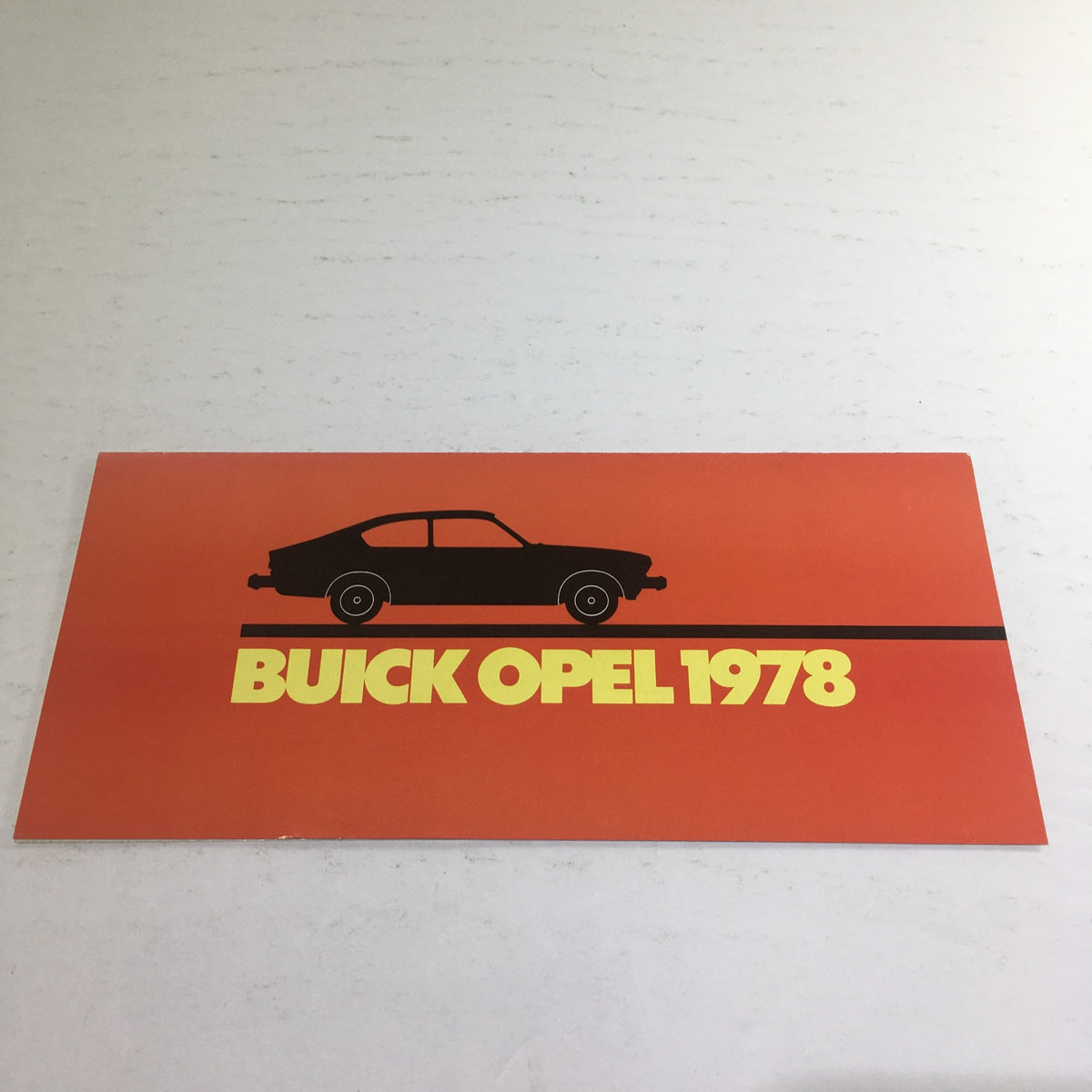 Front cover of the 1978 Buick Opel Sport Coupe Deluxe Sedan Dealership Car Auto Brochure, featuring a graphic silhouette of the car against an orange background.