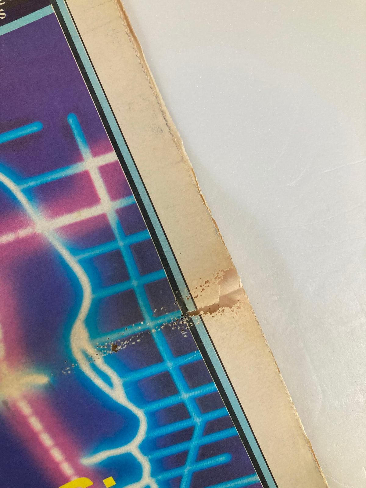Close-up view of the top corner of the VTG Inside Tennis Magazine May 1983, showing minor wear and damage while highlighting the magazine's vintage features.