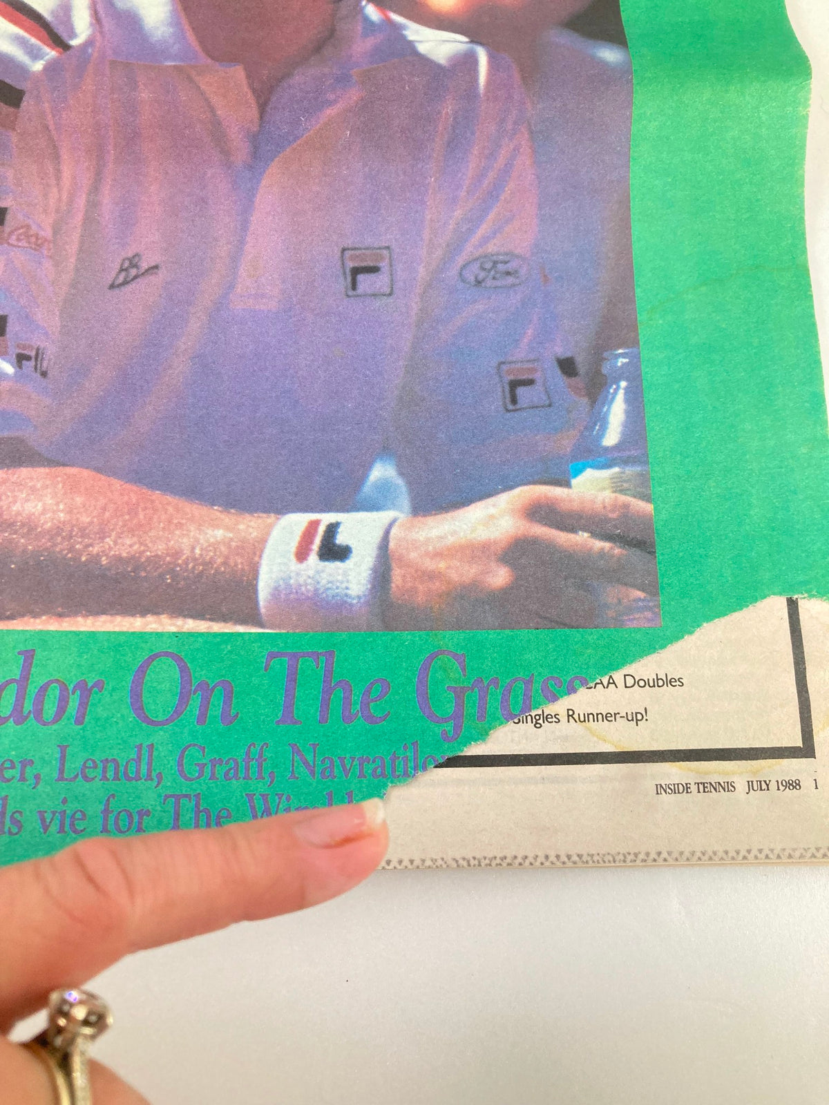 Close-up of the cover of Inside Tennis Magazine July 1988, highlighting the damaged edge while maintaining the title 'Splendor On The Grass', indicating its vintage condition and collectible nature.