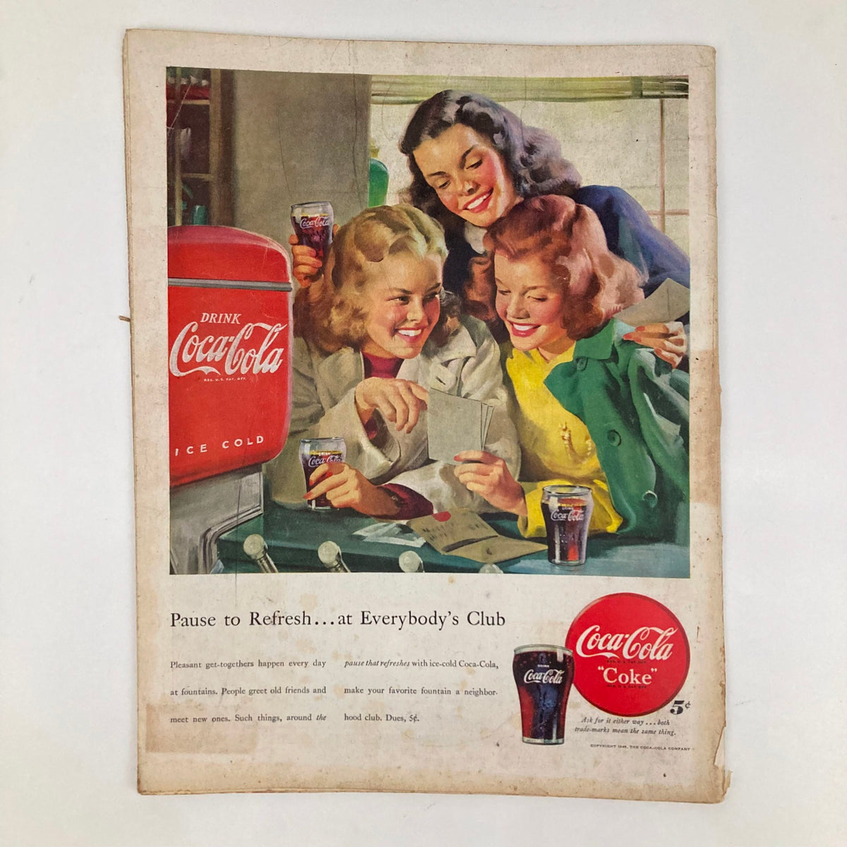Vintage Coca-Cola advertisement showcasing three women enjoying drinks together and viewing photographs. This image is featured in the Saturday Evening Post Magazine dated January 31, 1948.