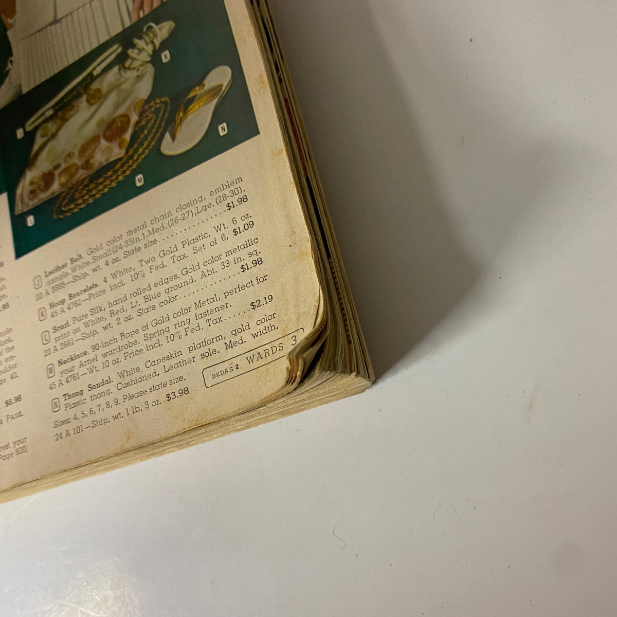 Close-up of the 1958 Montgomery Ward Spring and Summer Catalog showing detailed descriptions of fashion items and prices.