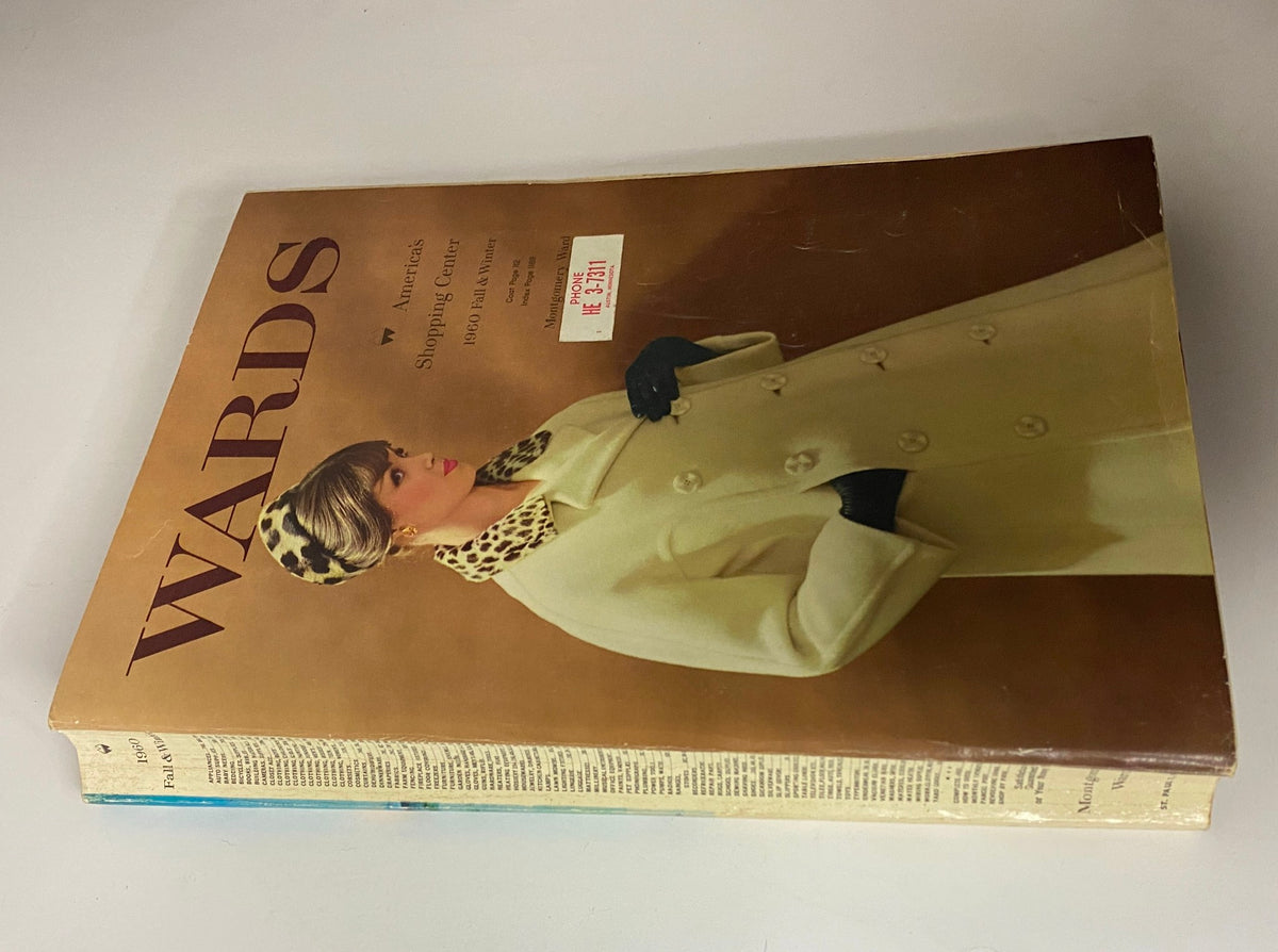 Side view of the 1960 Montgomery Ward Fall and Winter Catalog showcasing the cover with a model dressed elegantly in outerwear.