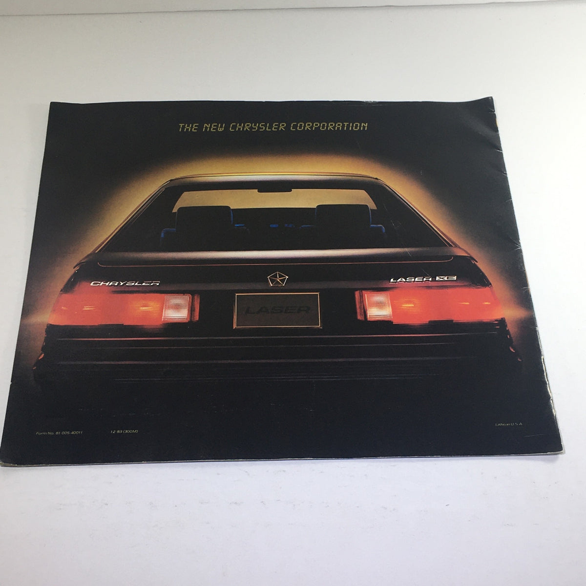 Back cover of the 1984 Laser XE by Chrysler Form #81005-40011 brochure with branding details visible.
