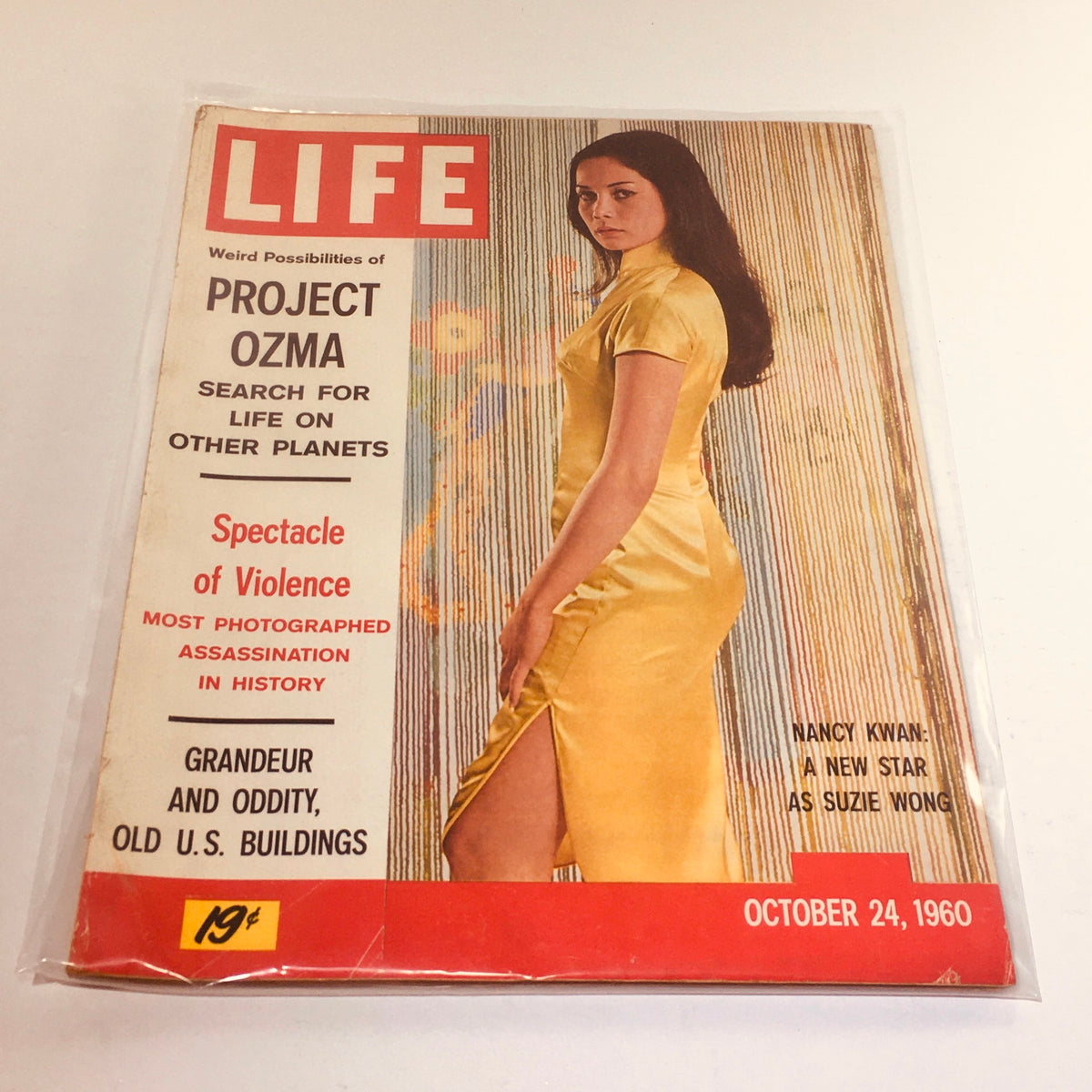 Vintage Life Magazine cover from October 24, 1960 featuring actress Nancy Kwan in a yellow dress, highlighting cultural themes such as 'Spectacle of Violence' and 'Project Ozma'