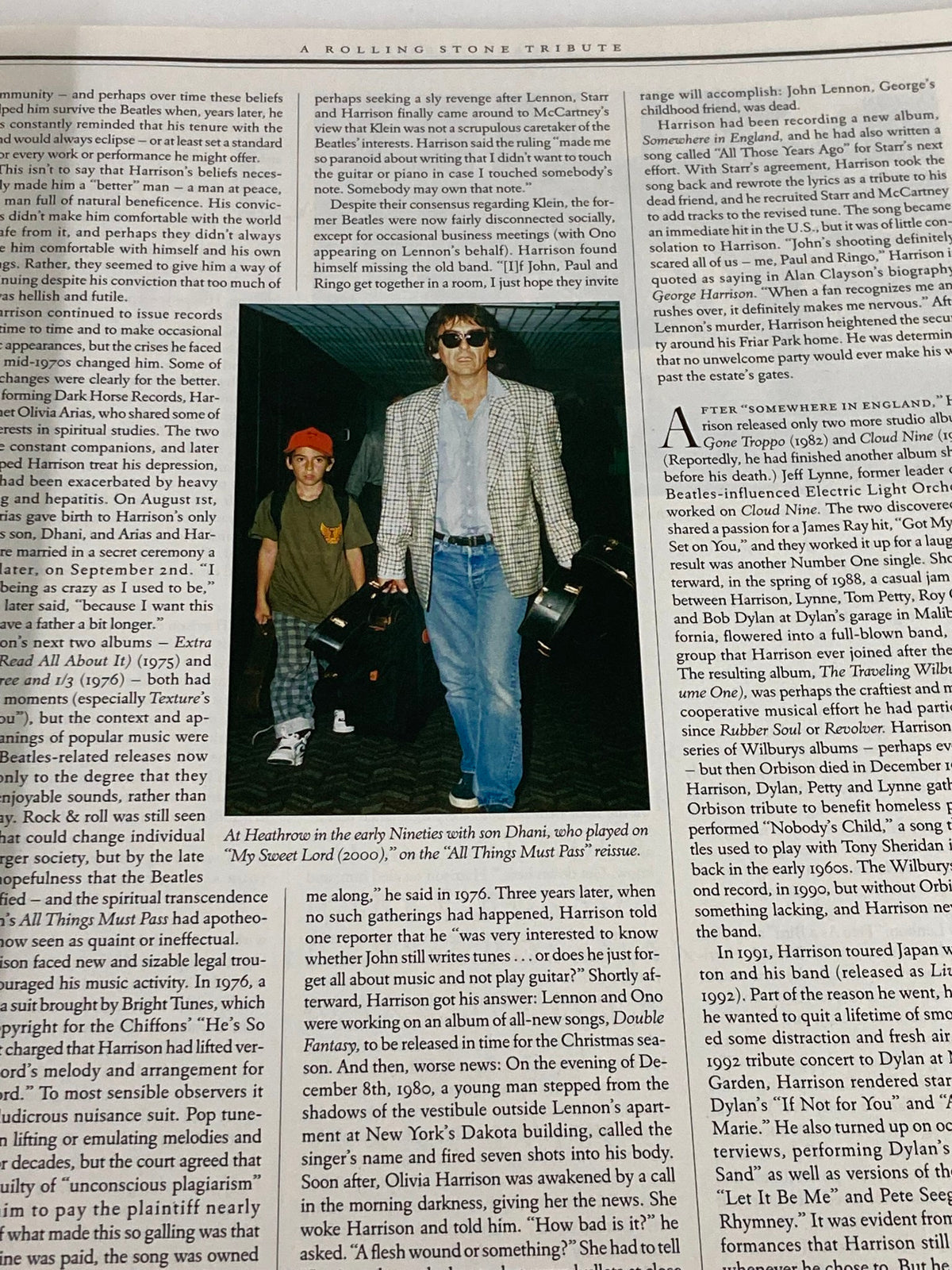 Image of George Harrison in the early 1990s with a child, highlighted in the Rolling Stone Magazine Special Edition 2001, showcasing a moment from his later career.