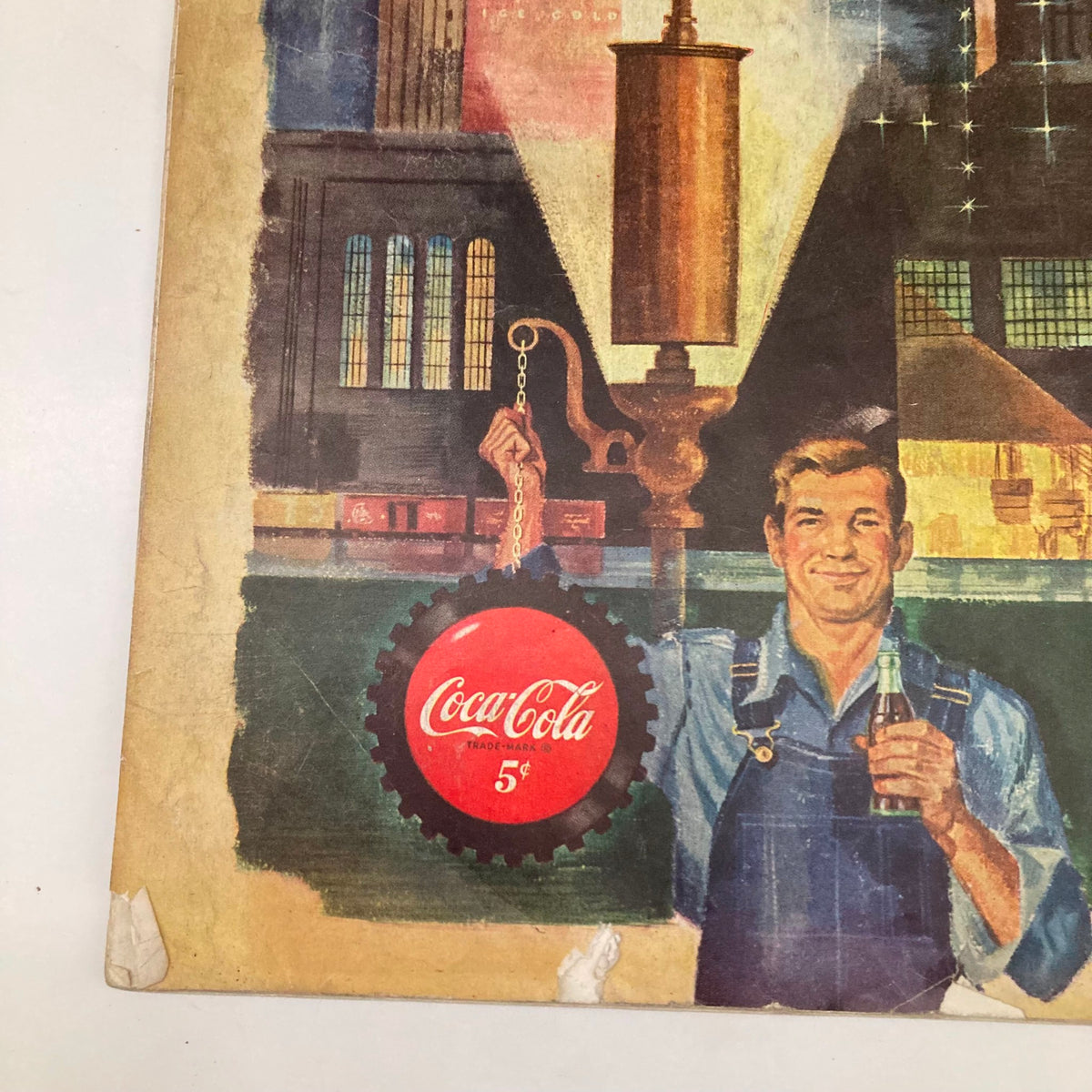 Close-up of Coca-Cola advertisement from the Saturday Evening Post Magazine December 30 1950, showcasing a man holding a Coca-Cola bottle with vintage branding.