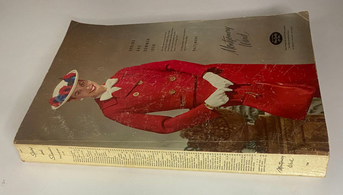 Side view of the 1958 Montgomery Ward Spring and Summer Catalog cover showcasing a woman dressed in a vibrant red ensemble, highlighting vintage fashion.