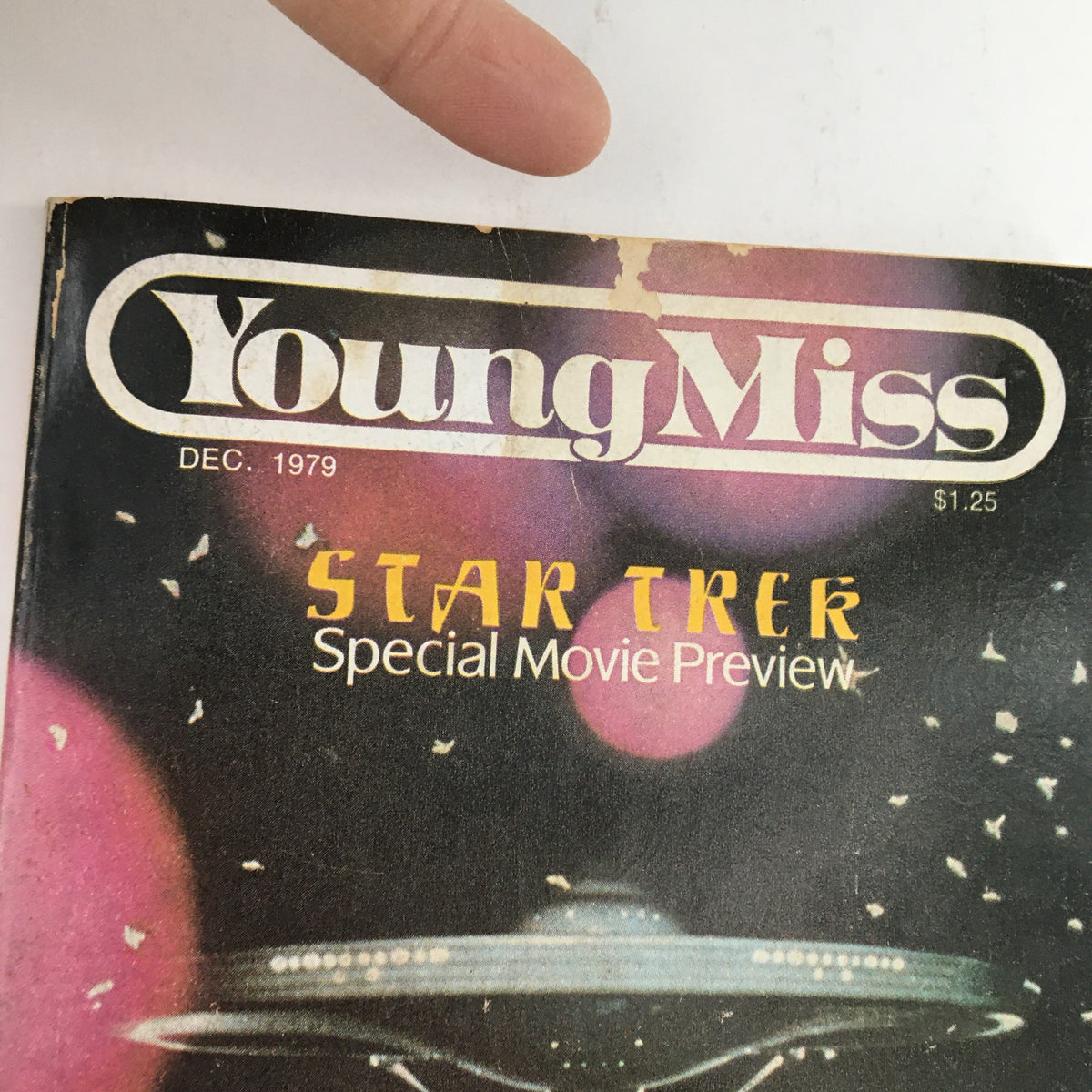 Close-up of the cover of Young Miss Magazine December 1979 showing the title and Star Trek Special Movie Preview with vibrant space imagery.