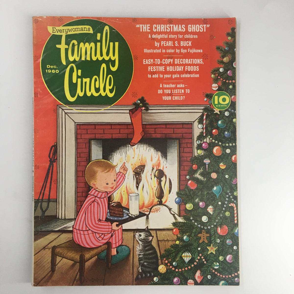 Cover of VTG Family Circle Magazine December 1960 featuring 'The Christmas Ghost' story by Pearl S. Buck, illustrated in color by Gyo Fujikawa, showing a child in pajamas beside a Christmas tree and fireplace.
