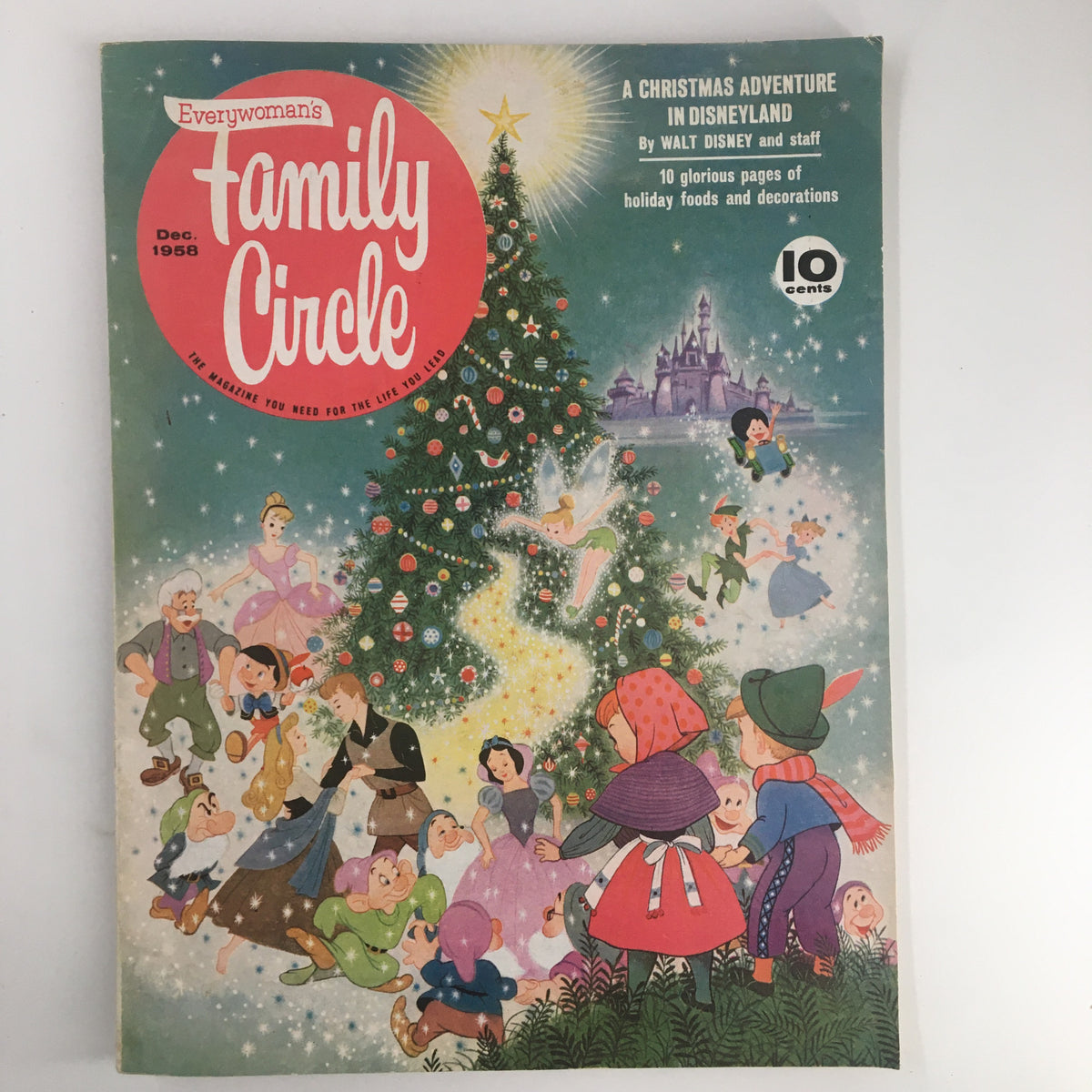 Cover of 'Family Circle' magazine from December 1958, featuring a Christmas theme with characters around a decorated tree and Disneyland in the background; highlights a festive adventure and holiday traditions.