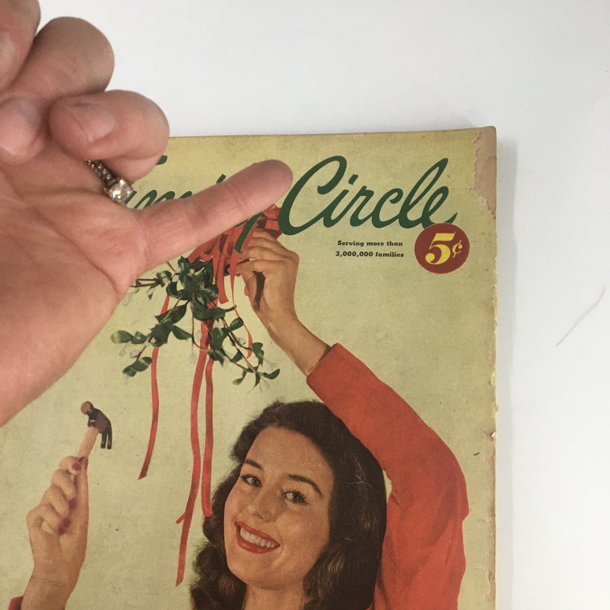Close-up image of the December 1951 Family Circle Magazine cover showing a woman smiling while holding mistletoe and ribbons, titled 'VTG Family Circle Magazine December 1951 Make A Cinnamon-Fruit Twist No Label.'
