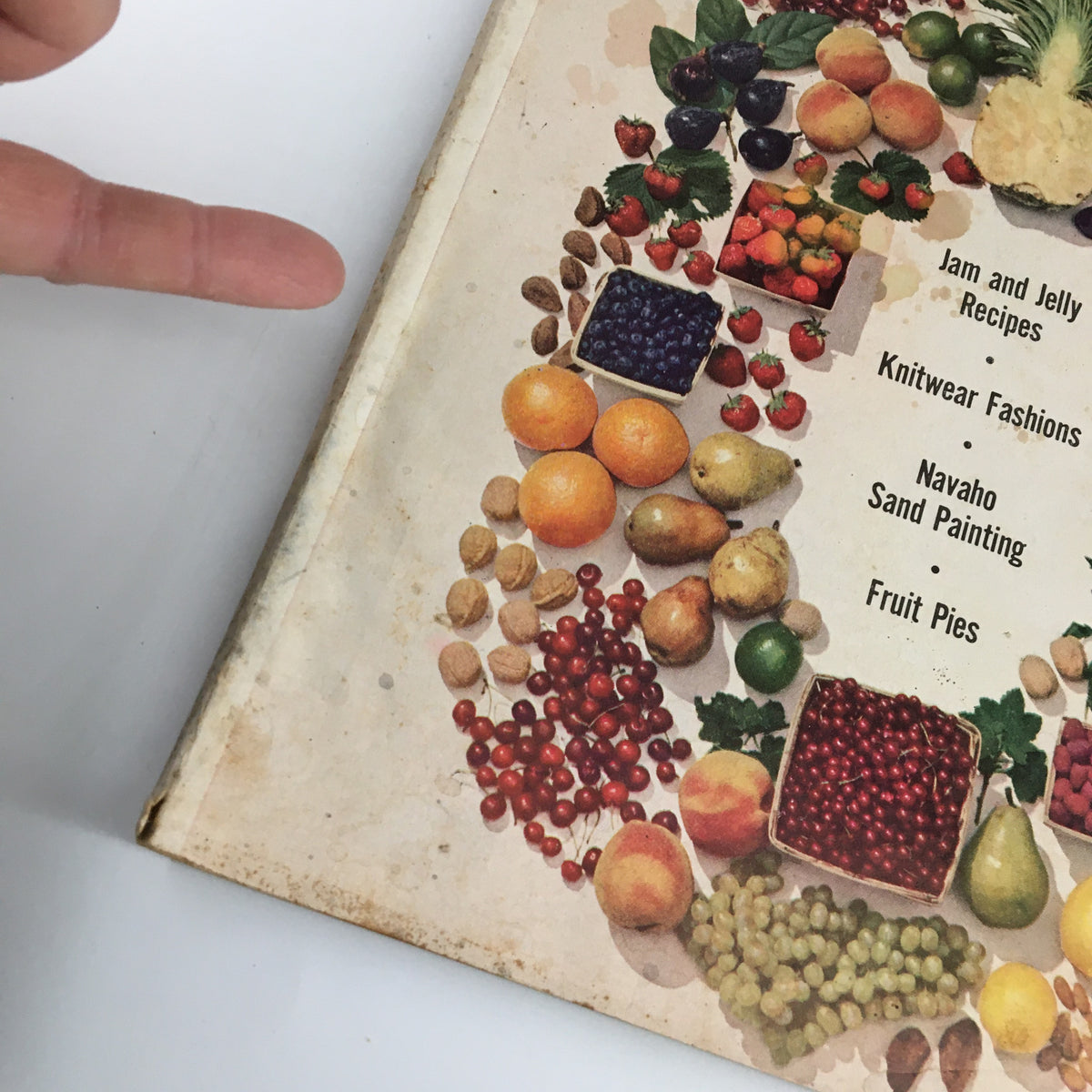 Detailed view of the cover of VTG Family Circle Magazine July 1953 showcasing the various fruits and the listed contents including Navajo sand painting.