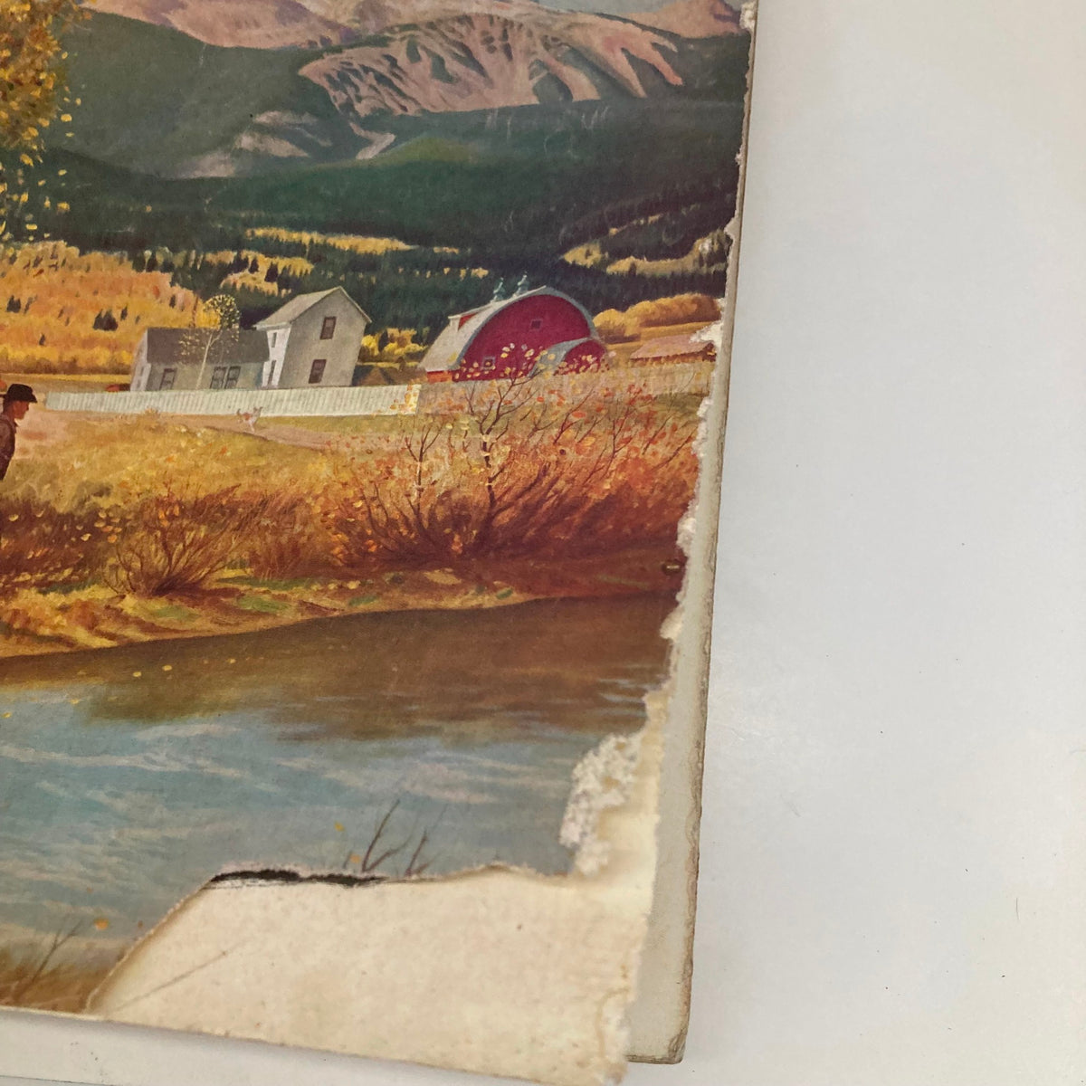 Close-up of the edge of the Saturday Evening Post October 13 1951 cover, highlighting the illustrated farm scene with autumn foliage.