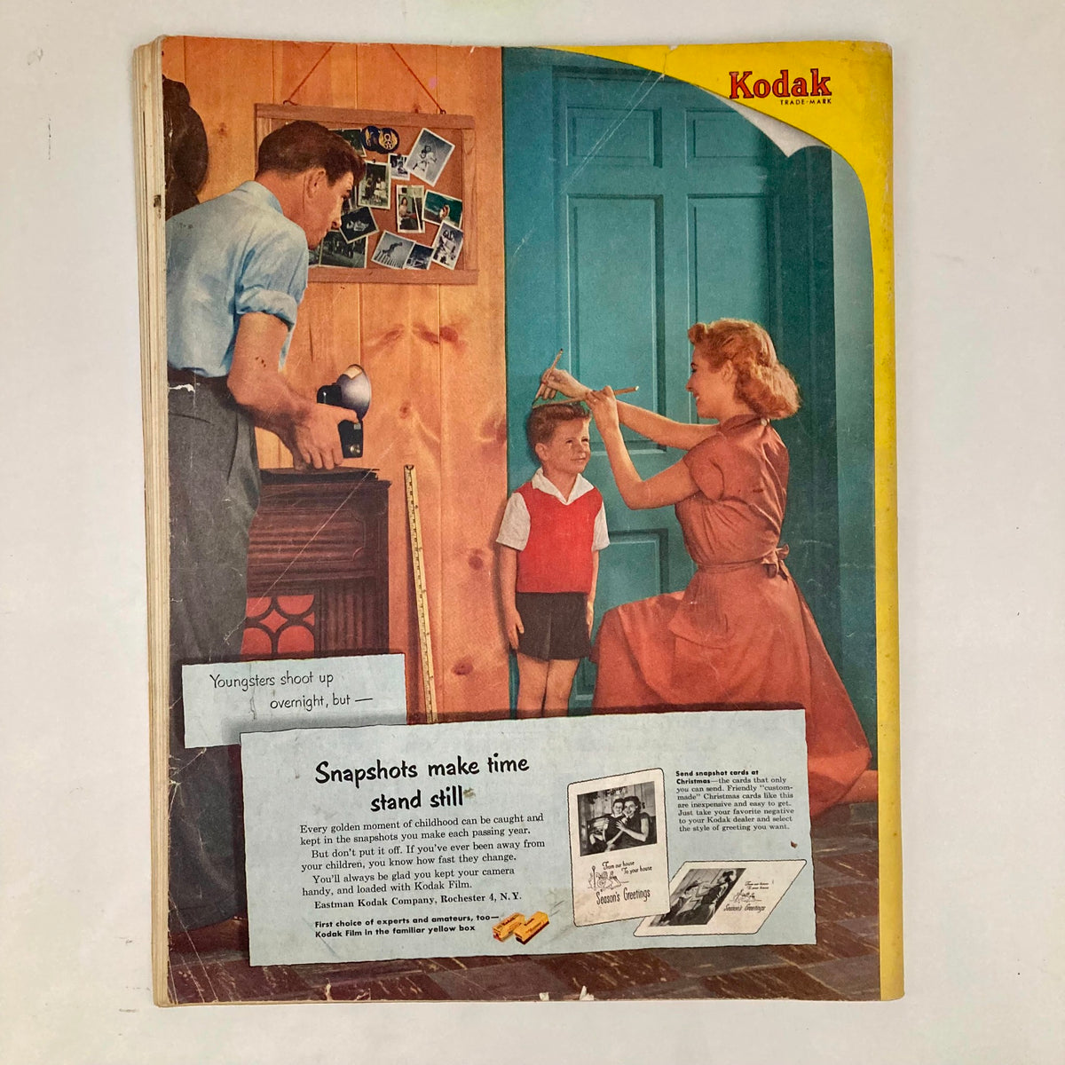 Cover of Saturday Evening Post Magazine dated November 22, 1952, showcasing a family scene, with a woman cutting a boy's hair in front of a colorful background, representing nostalgia and early 1950s culture.