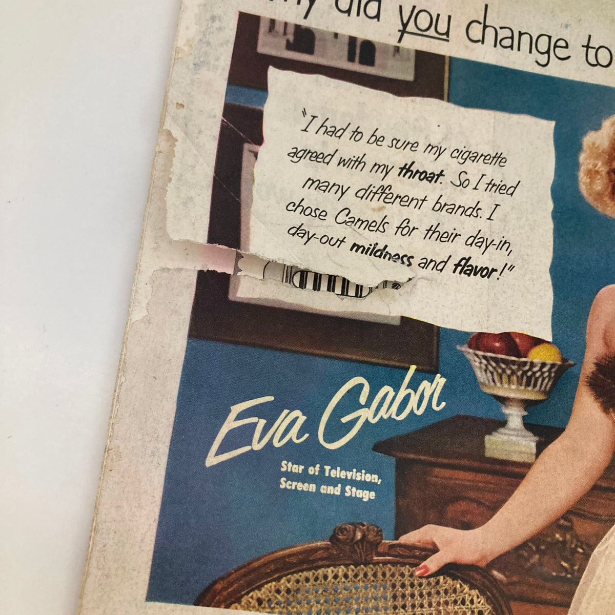 Cover detail of Saturday Evening Post Magazine February 9 1952 featuring Eva Gabor endorsing Camels cigarettes. The image highlights vintage advertising aesthetics with a torn paper text quote.