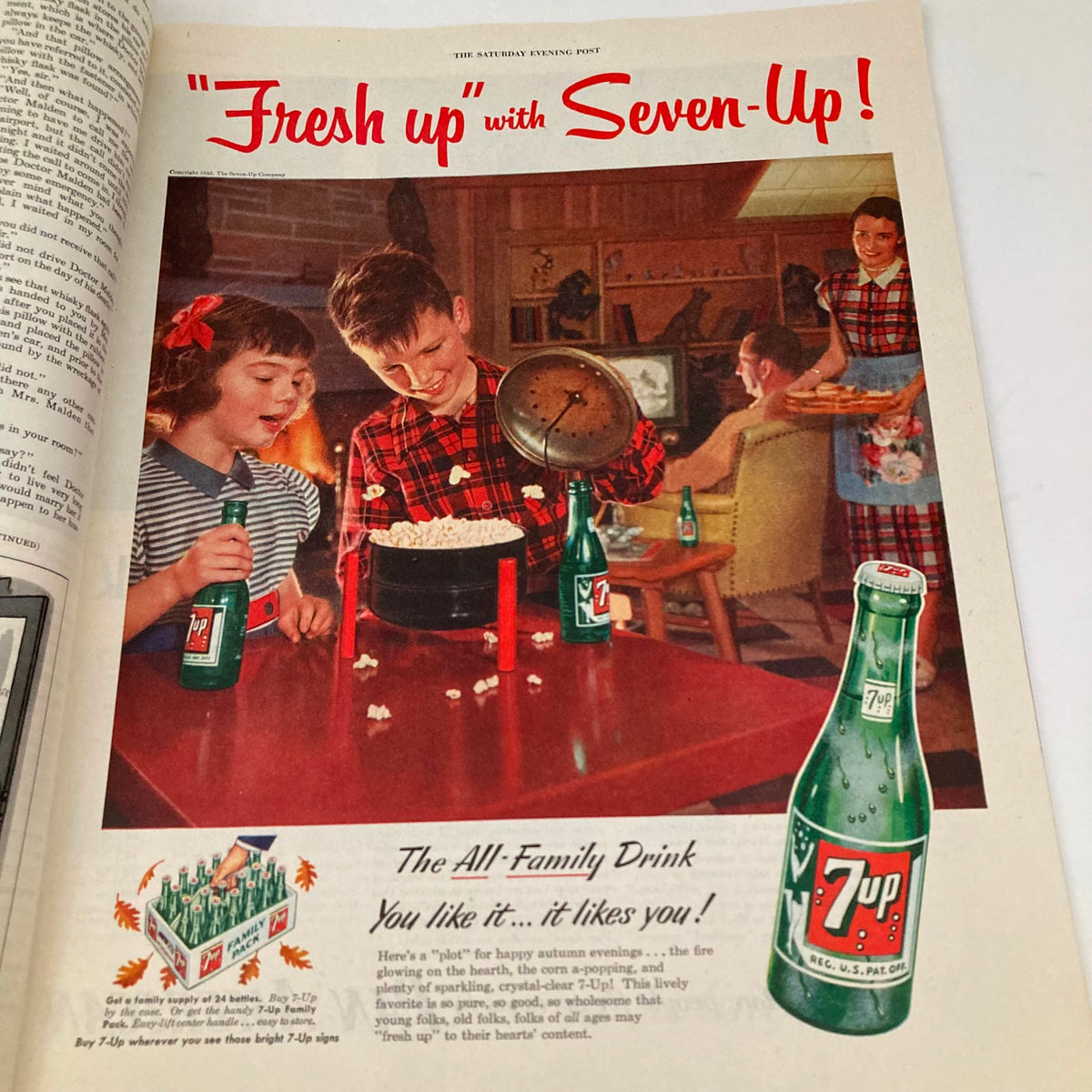 Seven-Up soda advertisement in the Saturday Evening Post Magazine dated October 17, 1953, featuring children enjoying popcorn with bottles of Seven-Up, promoting the beverage as the all-family drink.