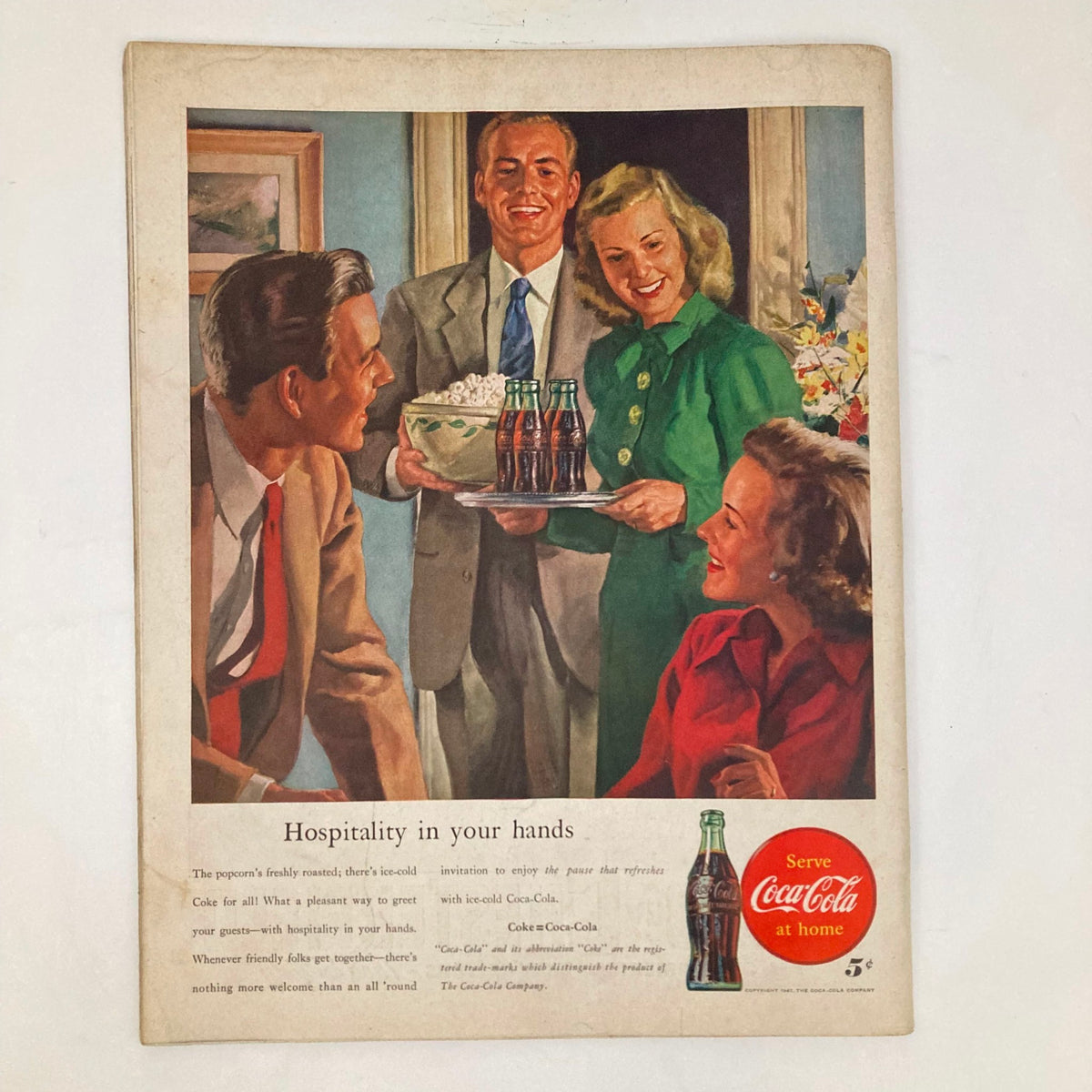 Coca-Cola advertisement in the Saturday Evening Post Magazine March 1, 1947, depicting a group of friends enjoying hospitality with drinks and popcorn.