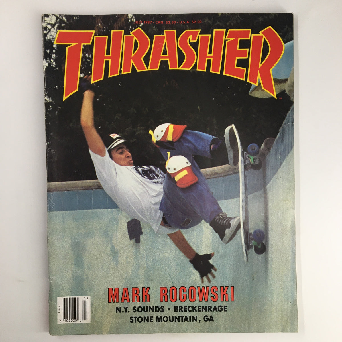 Cover of VTG Thrasher Magazine July 1987 featuring Mark Rogowski performing a trick at the X-Acto Pool, a vintage collectible encapsulating 80s skate culture.