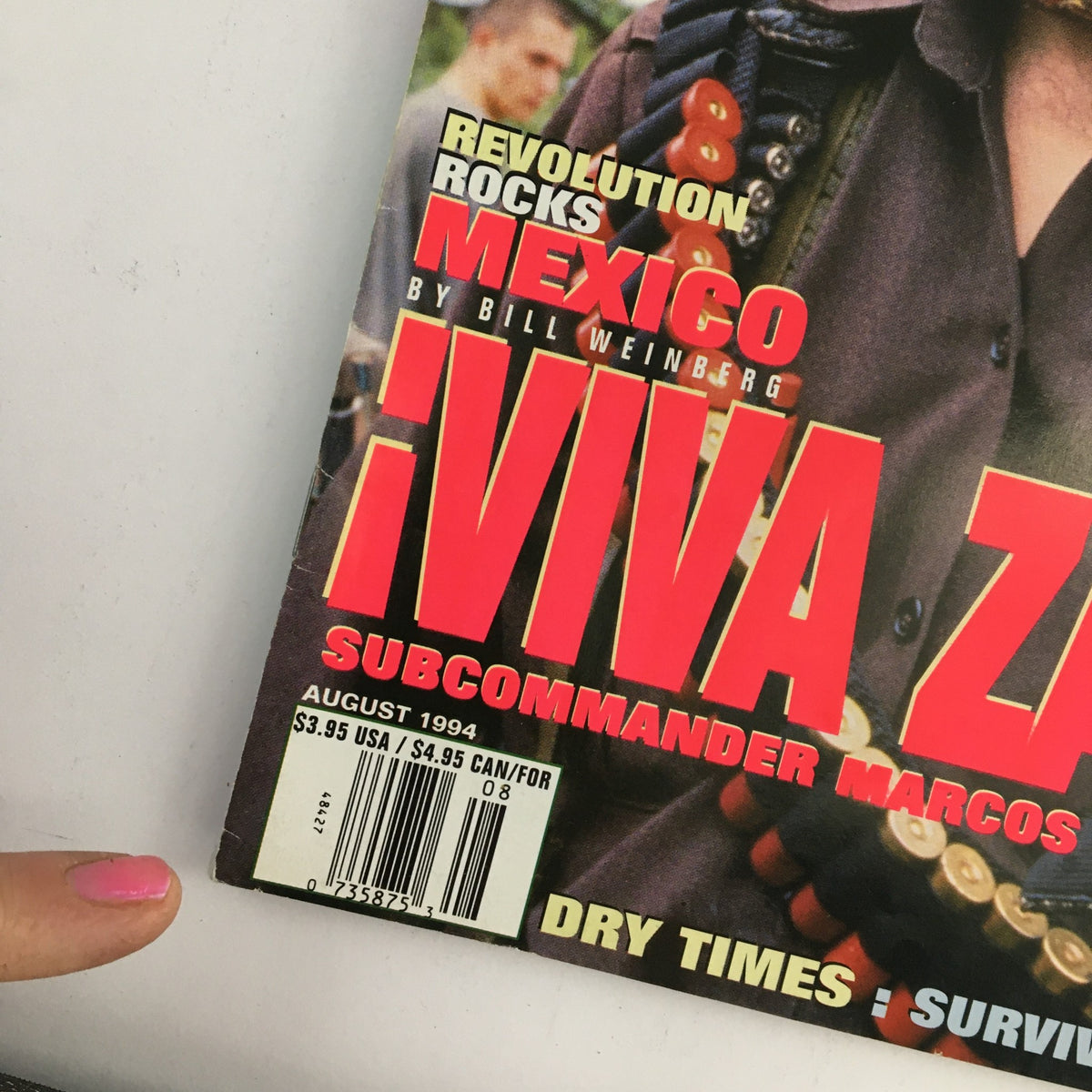 Detailed view of the bottom section of the High Times Magazine August 1994, showcasing the publication date and the price, along with prominent text '¡Viva Zapata! Sub Commander Marcos'.