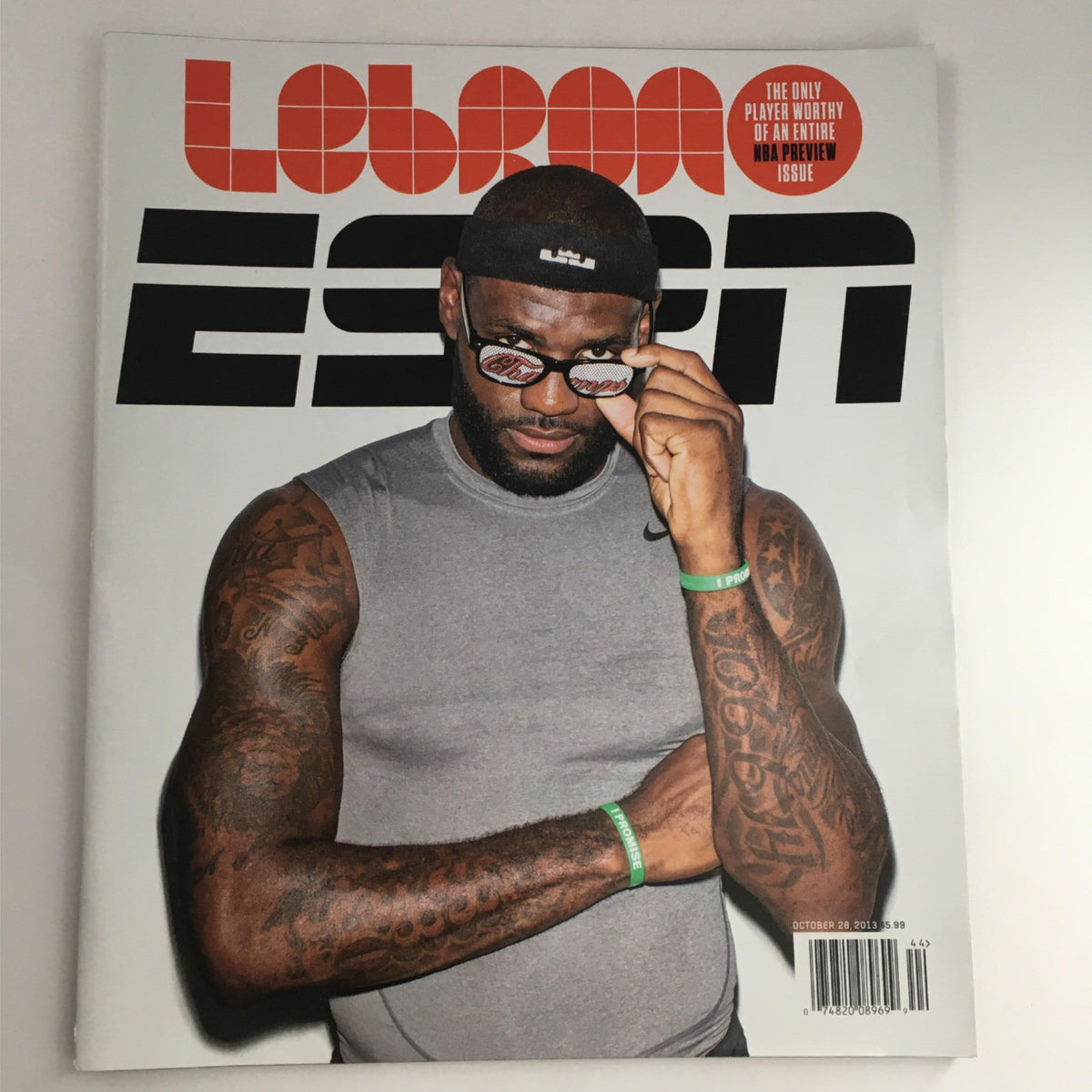 Cover of ESPN Magazine October 28, 2013 featuring NBA star LeBron James, showcasing his muscular physique and distinctive tattoos while adjusting his glasses.