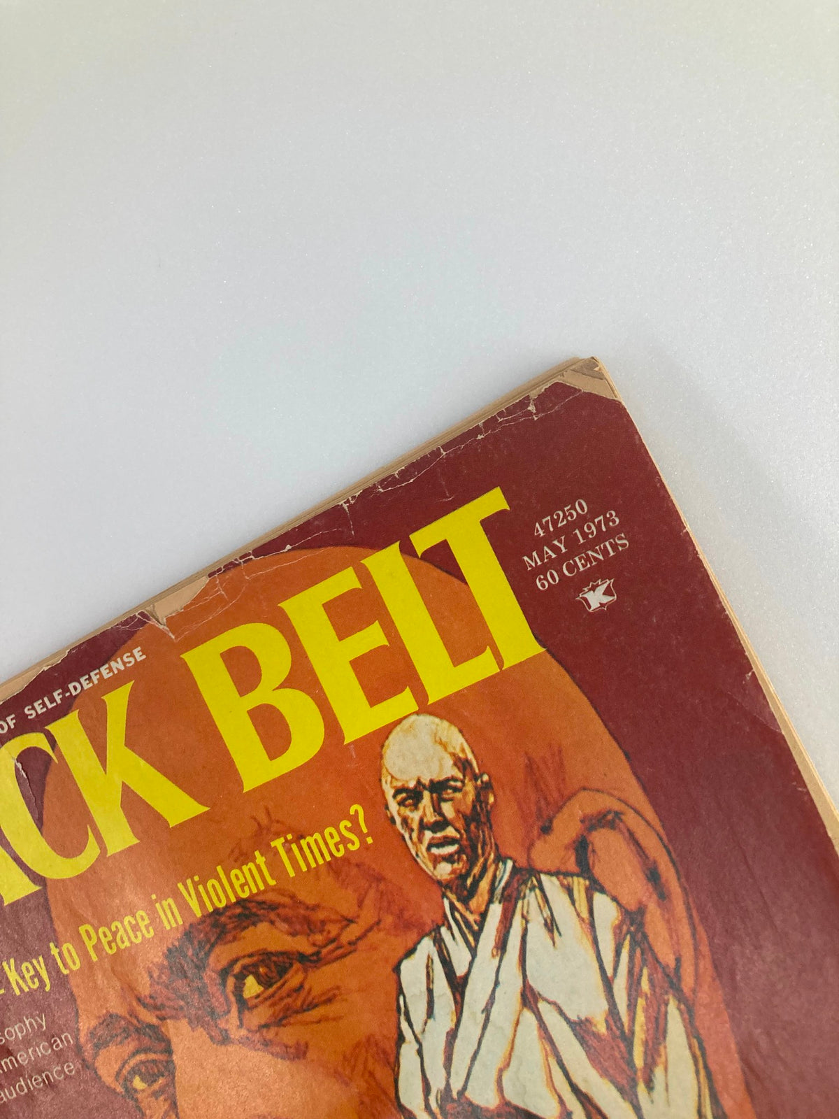 Detail view of the corner of the VTG Black Belt Magazine May 1973 cover titled 'Walk A Few Steps and Gasp For Air', emphasizing the bold 'Black Belt' title and martial arts illustration.