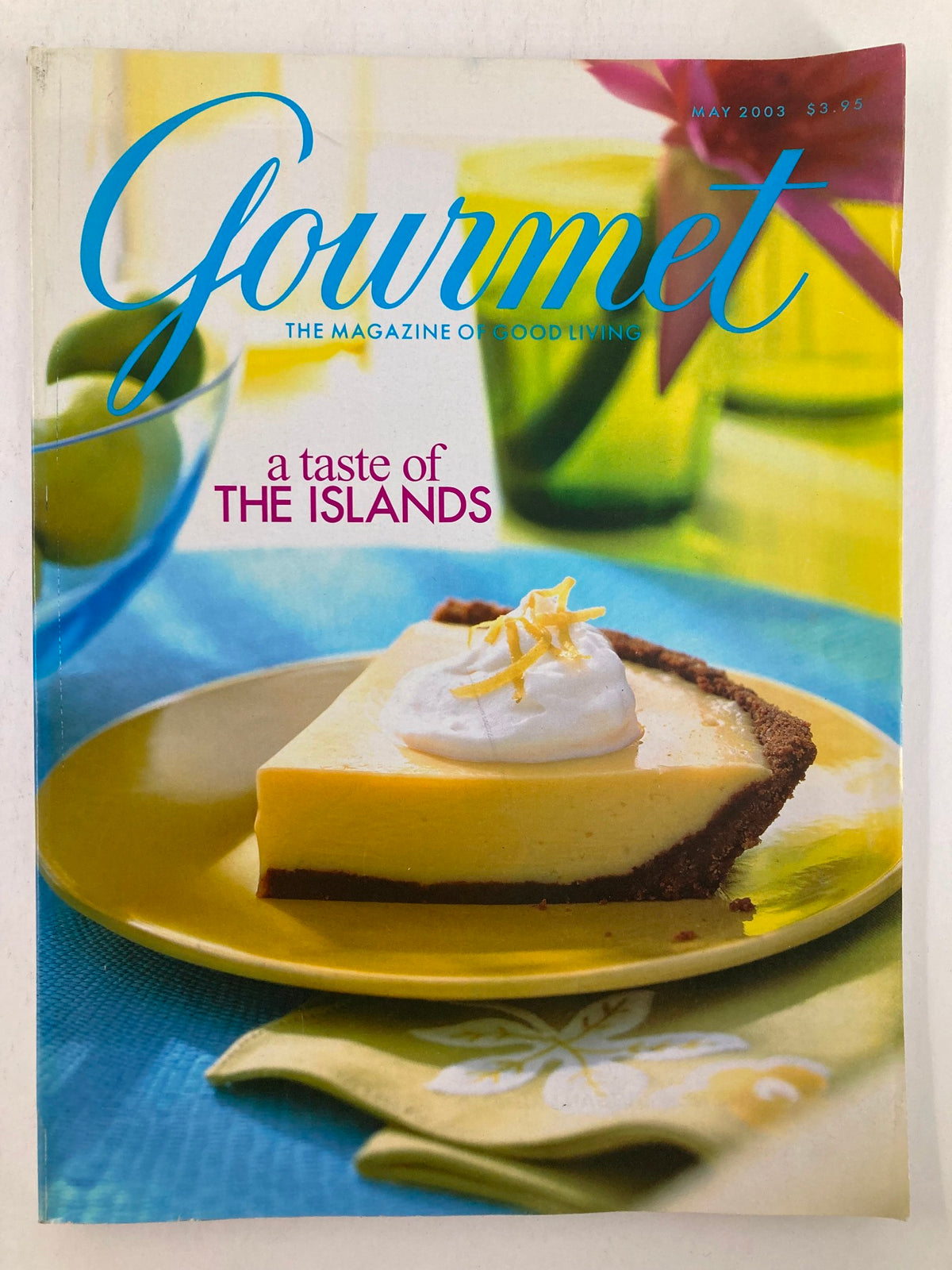 Cover of Gourmet Magazine May 2003 featuring a delectable slice of dessert with a tropical theme, titled 'A Taste of the Islands', highlighting vibrant colors and culinary artistry.