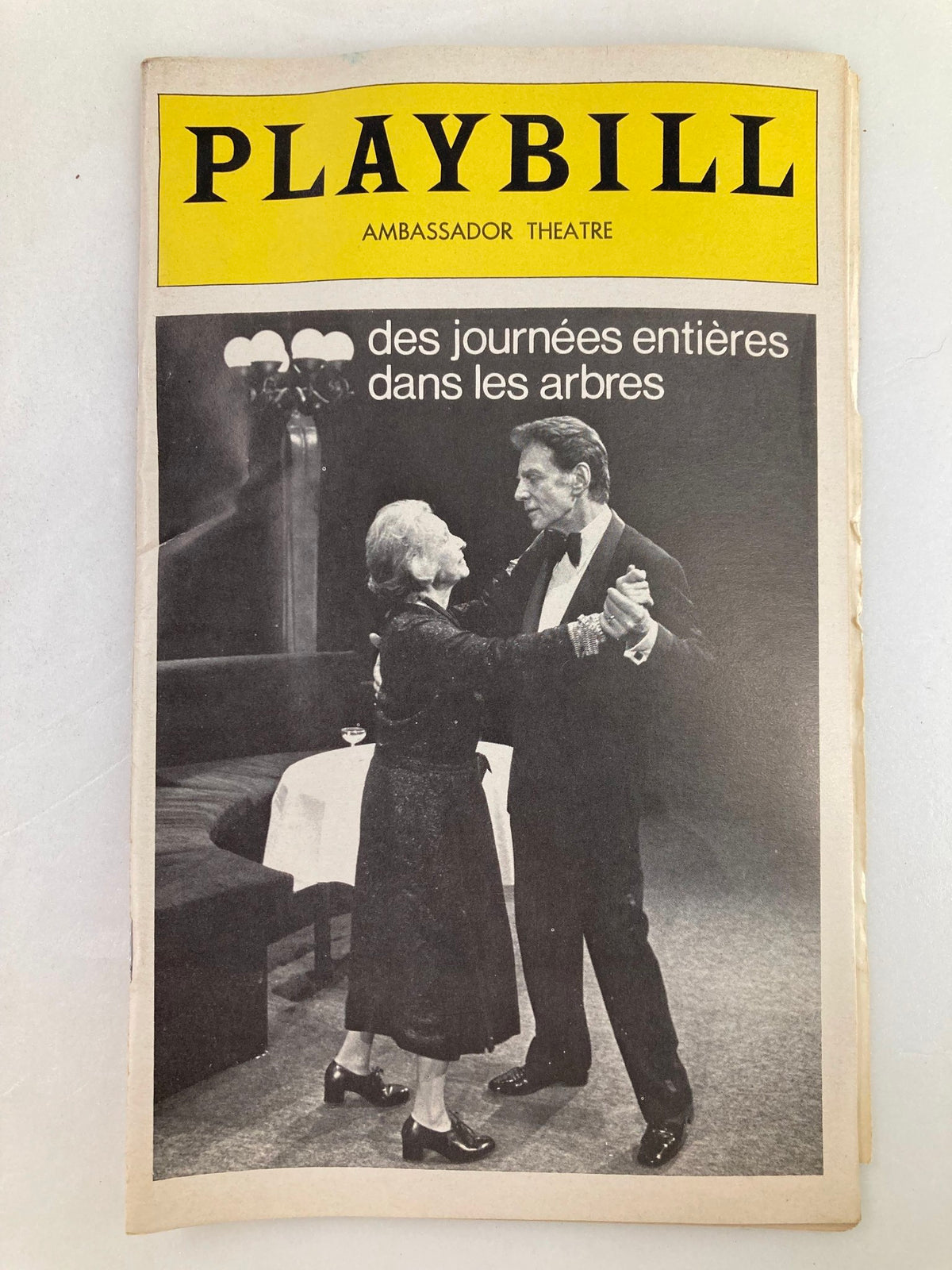 1976 Playbill from Ambassador Theatre featuring the production 'Des Journees Entieres Dans Les Arbres', showcasing a black and white image of actors dancing on stage.