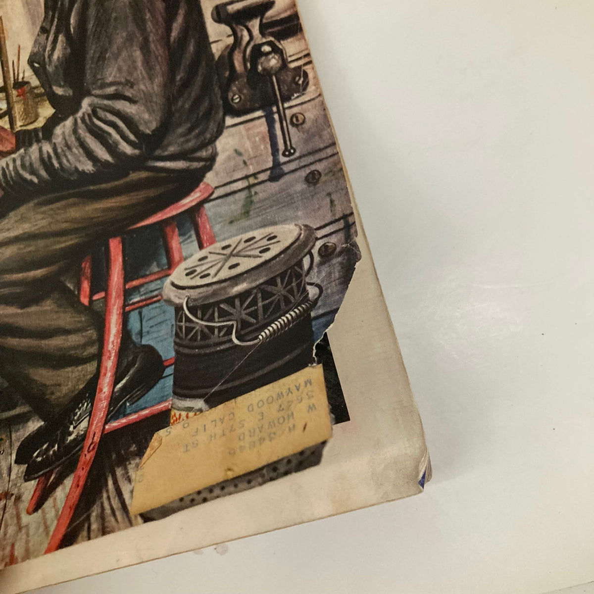 Close-up of the cover of Saturday Evening Post Magazine from November 12, 1949, highlighting wear and tear, with visible details like a doll and tools indicating the theme of 'Mr. Fix-It'.