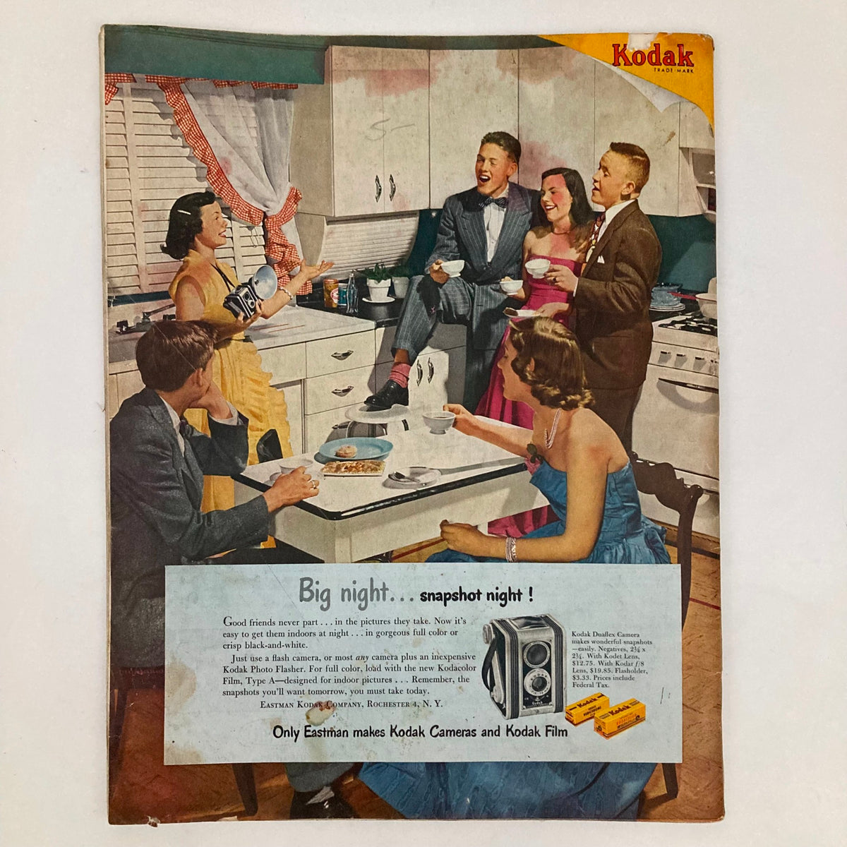 Kodak advertisement from Saturday Evening Post Magazine February 18 1950, depicting a social gathering in a kitchen with friends enjoying snacks and showcasing Kodak cameras and film for capturing memories.