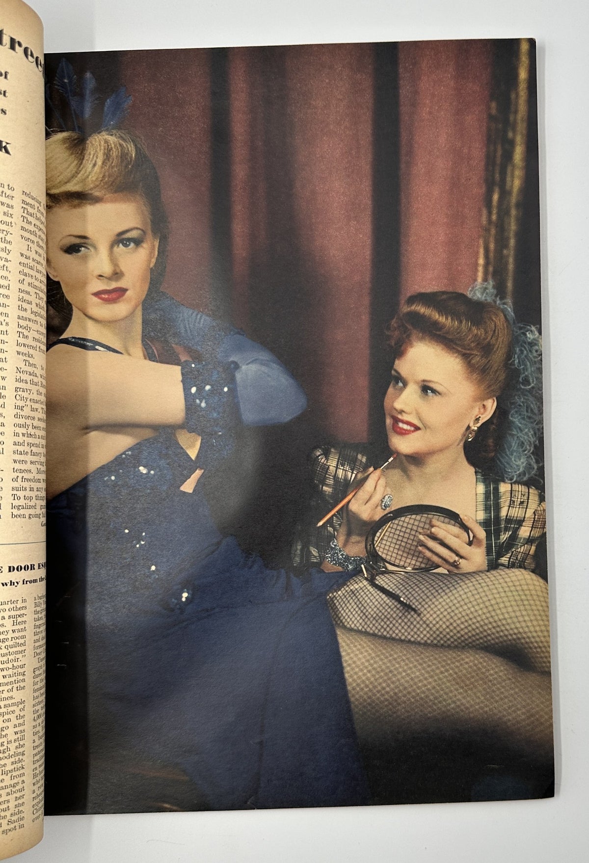 Page from Esquire Magazine July 1944 displaying a glamorous image of two women in elegant attire, one of them wearing a dazzling gown while the other holds a mirror.