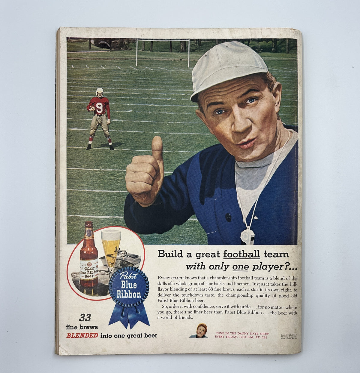 Cover page of Esquire Magazine, November 1945 featuring a football player and branded beer advertisement.
