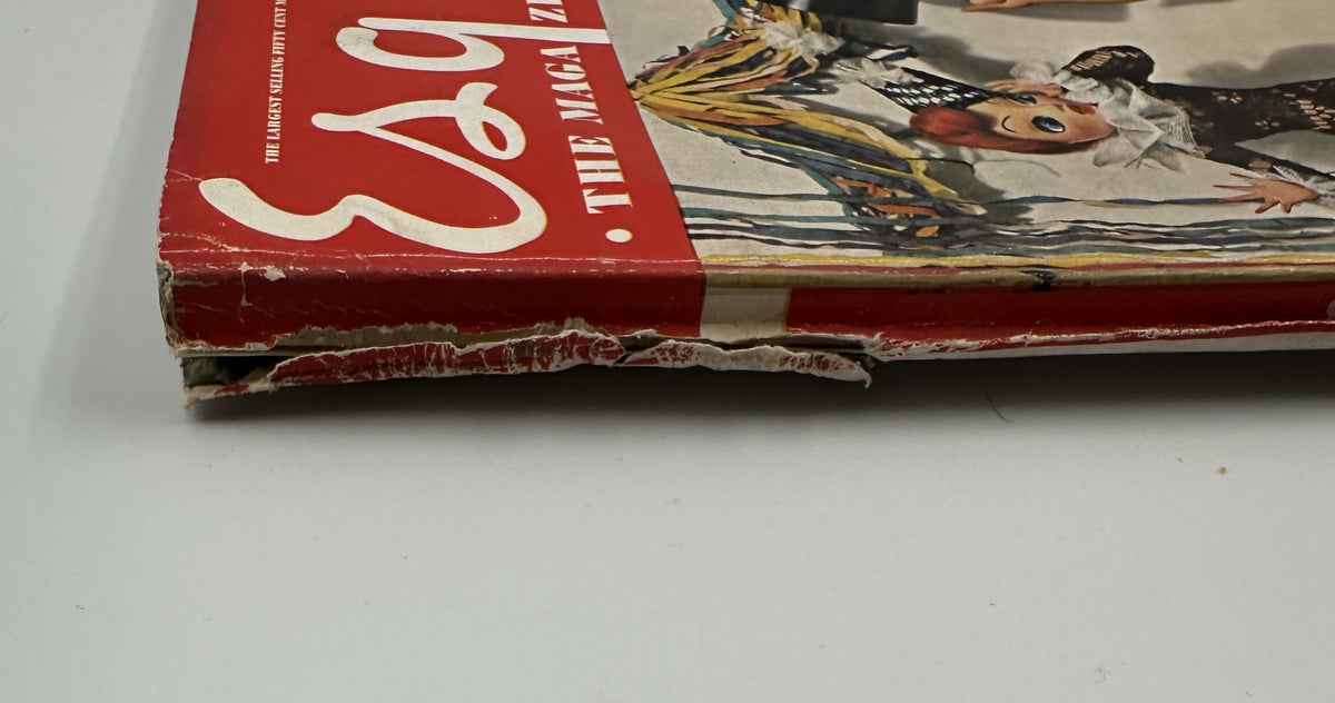Close-up of the worn edge of Esquire Magazine January 1943, featuring the cover design with festive characters and showcasing its vintage condition.