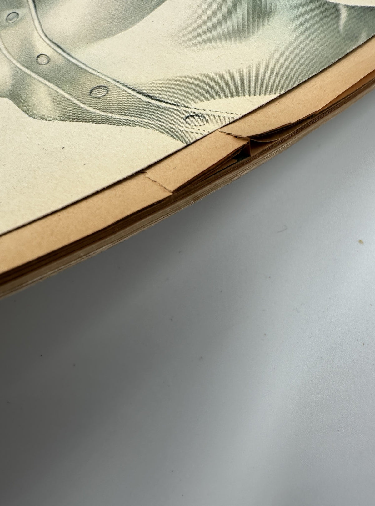 Close-up of the binding of Esquire Magazine April 1944, displaying signs of wear and the age of the publication.