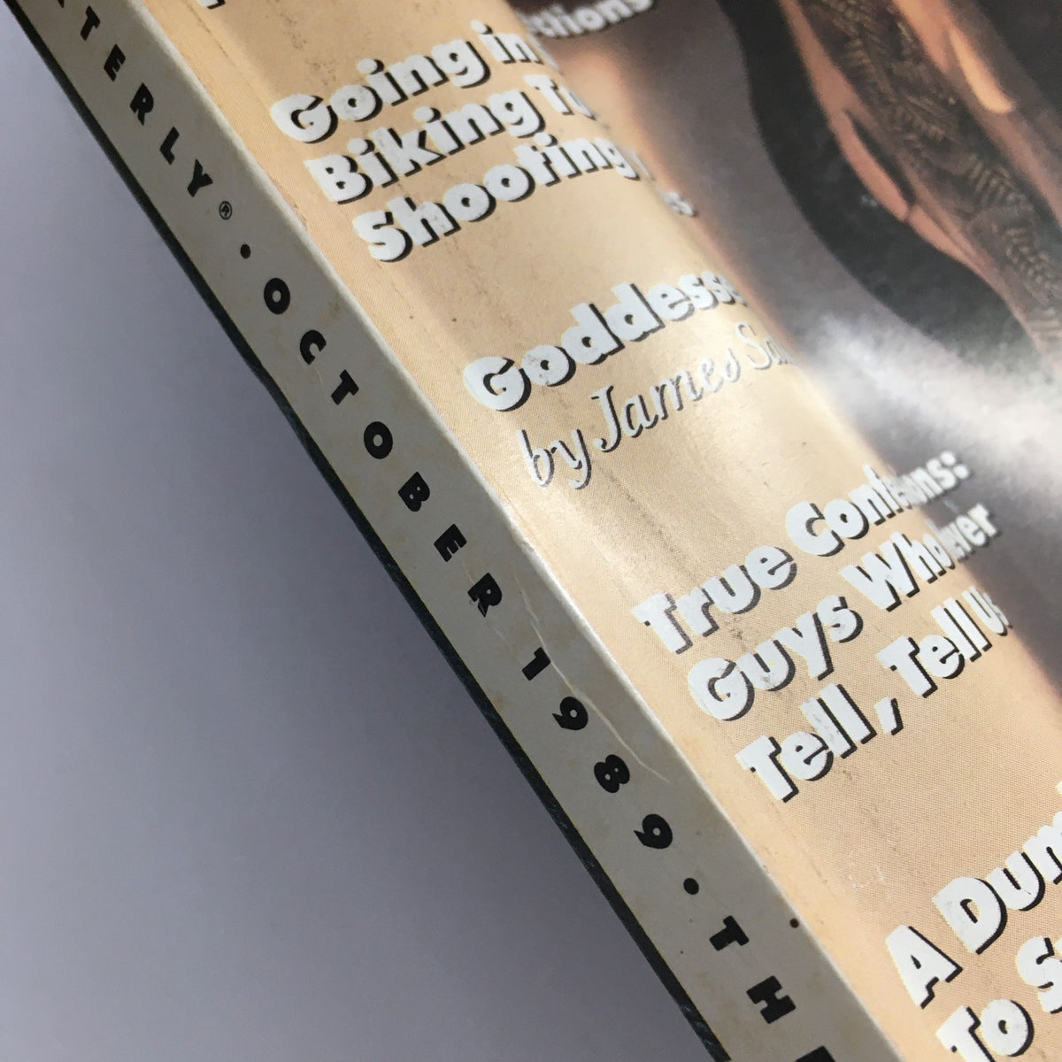 Close-up shot of the spine and side cover of GQ Magazine October 1989, featuring titles like 'Going in Style' and 'Goddesses' by James Stalker, highlighting the publication's diverse content and vintage appeal.