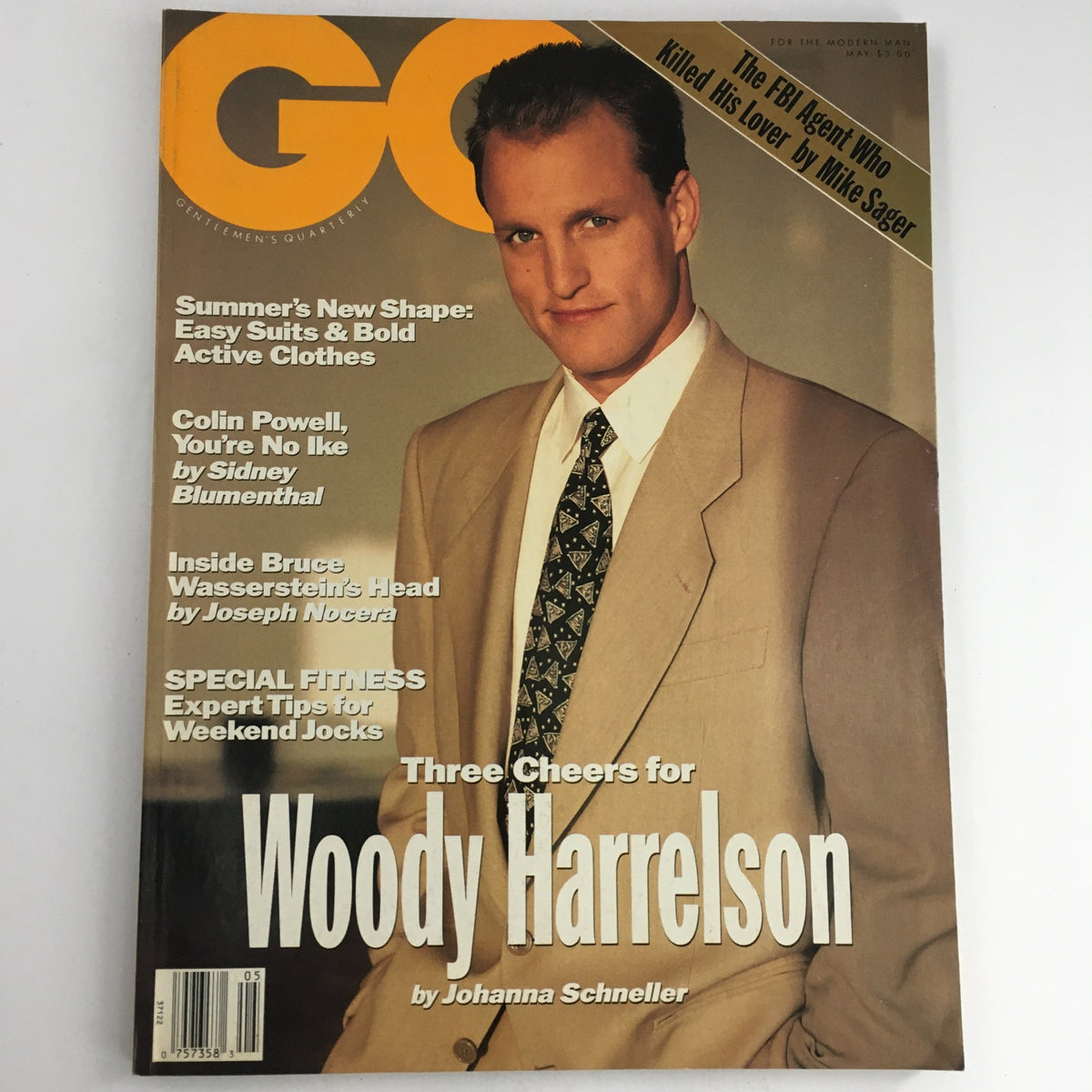 GQ Magazine May 1991 featuring Woody Harrelson on the cover, showcasing the actor's stylish appearance in a beige suit with a patterned tie, highlighted by the magazine's title and additional articles of interest.