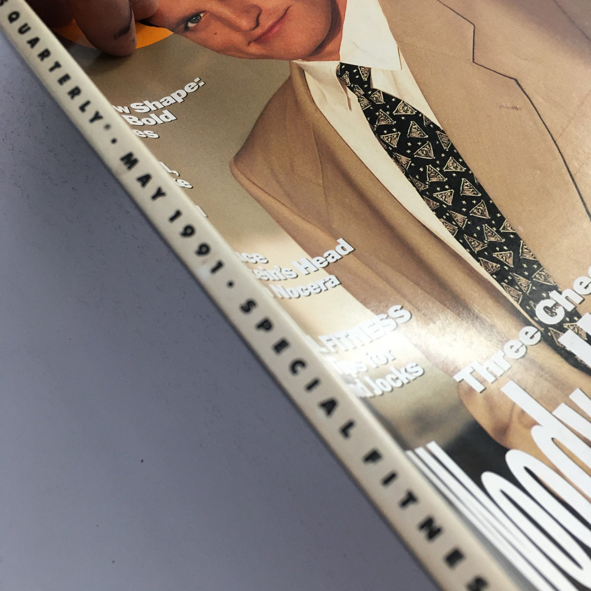 Cover image of GQ Magazine May 1991 featuring Woody Harrelson, showcasing fashion and celebrity culture from the early '90s, with the title 'Three Cheers for Woody Harrelson' prominently displayed.