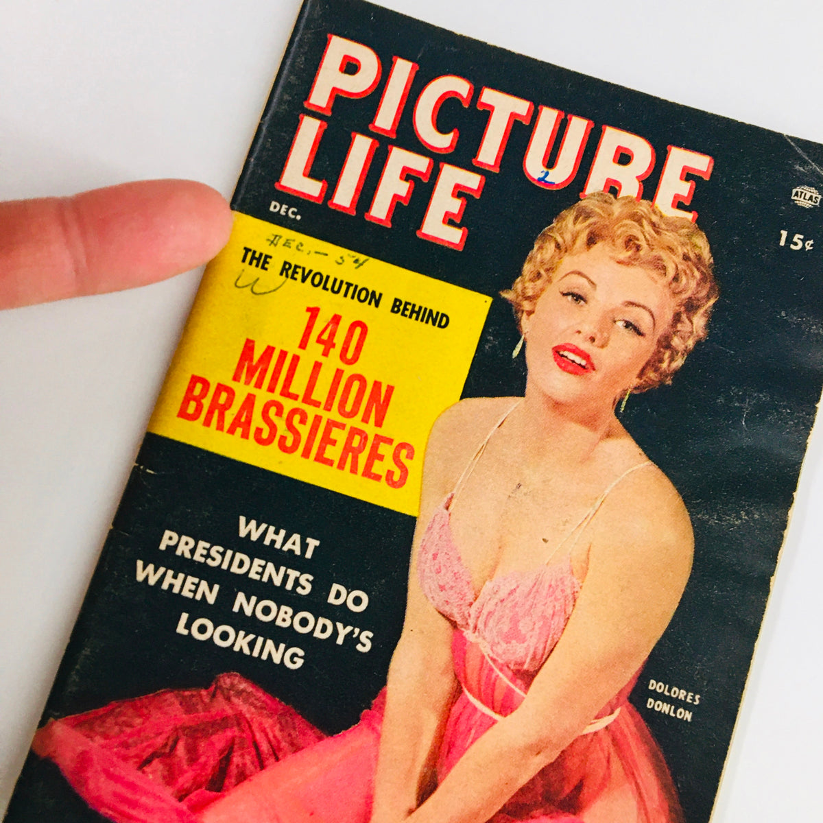 Close-up of the cover of VTG Picture Life Magazine December 1954 with Dolores Donlon, emphasizing vintage fashion and the intriguing title 'What Presidents Do When Nobody's Looking.'