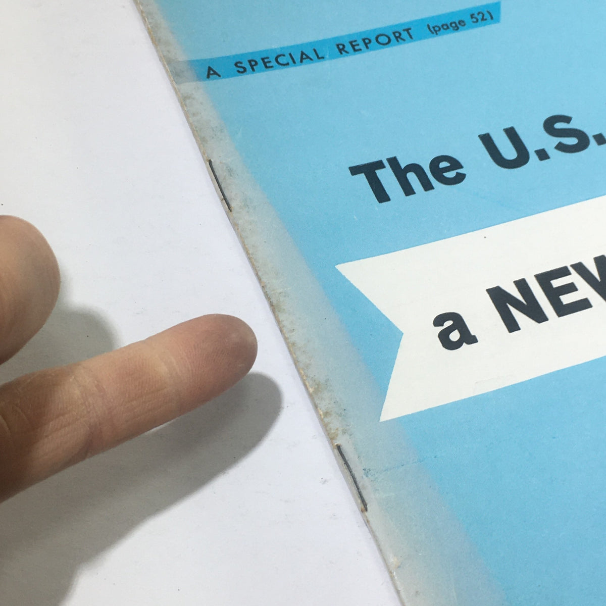Close-up view of the cover of Business Week Magazine from January 23, 1960, highlighting the title "The U.S. Invents A New Way To Grow" with a finger pointing at it.